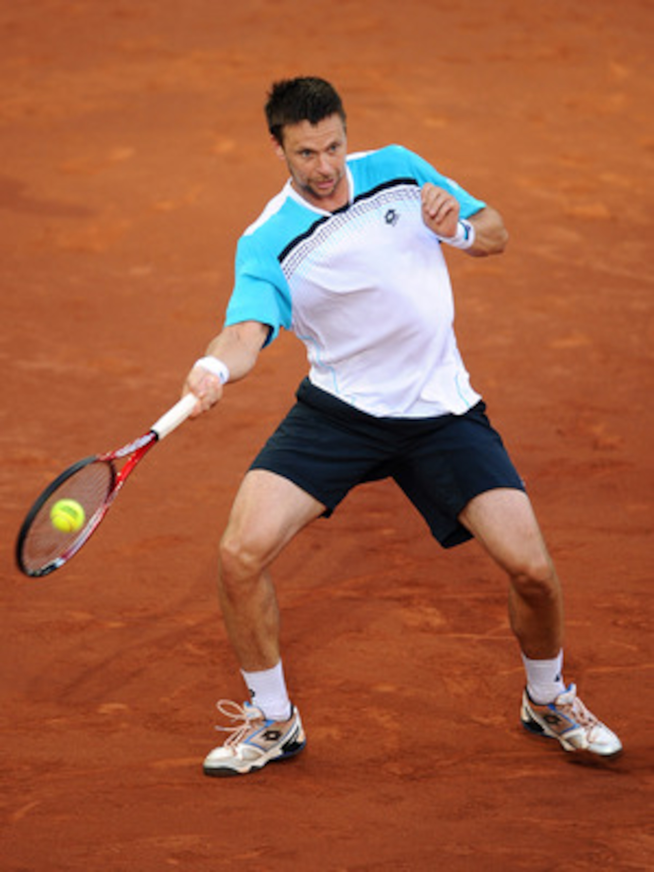 MADRID, SPAIN - MAY 06:  Robin Soderling of Sweden plays a backhand to Roger Federer of Switzerland during day seven of the Mutua Madrilena Madrid Open Tennis on May 6, 2011 in Madrid, Spain. Federer won the match in straight sets.  (Photo by Jasper Juine
