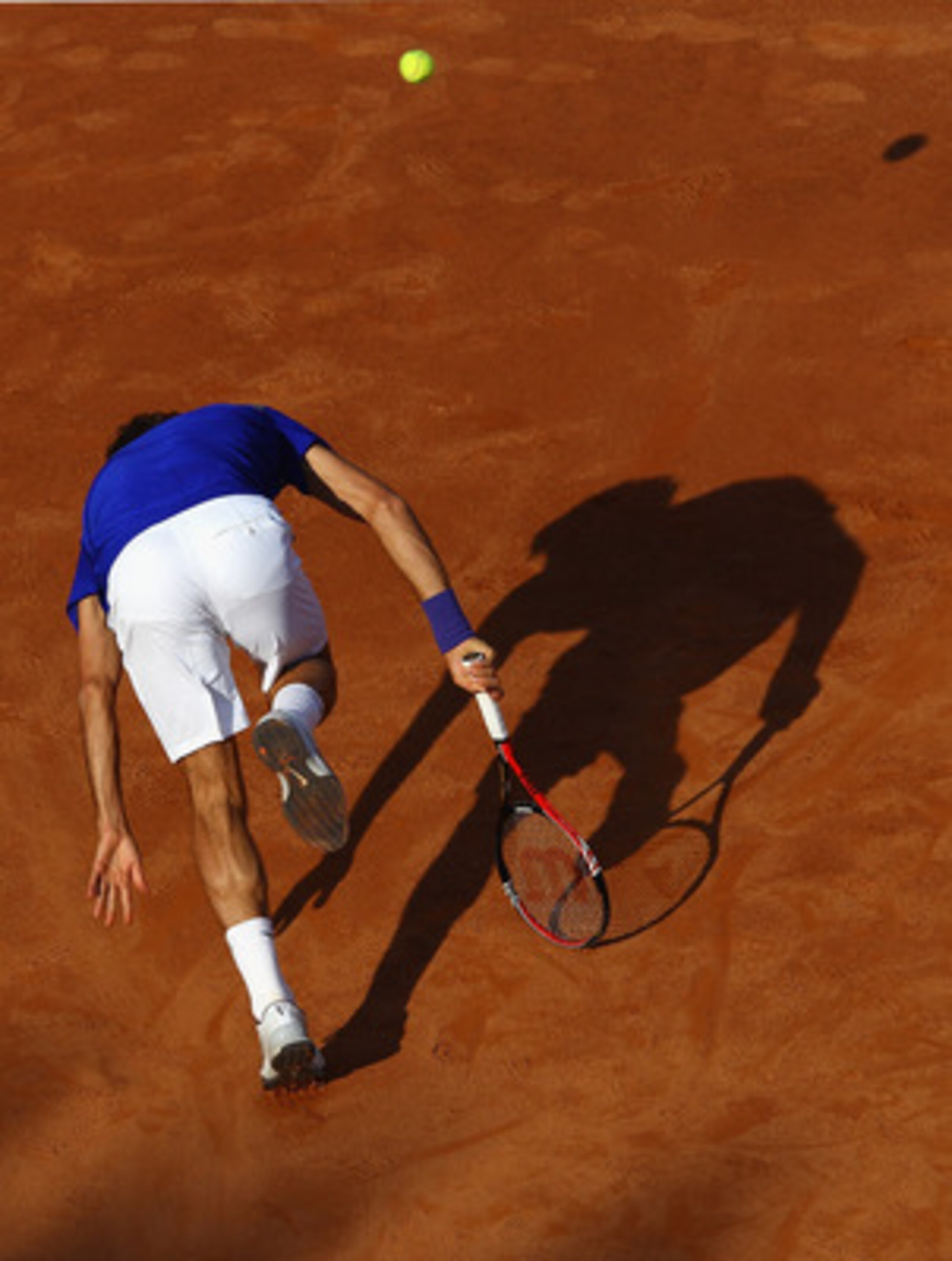 ROME, ITALY - MAY 12:  Roger Federer of Switzerland chases a ball on his way to defeat during his third round match against Richard Gasquet of France during day five of the Internazoinali BNL D'Italia at the Foro Italico Tennis Centre on May 12, 2011 in R