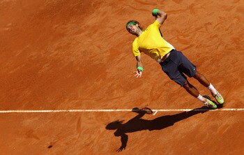 ROME, ITALY - MAY 13: Rafael Nadal of Spain serves during his quarter final match against Marin Cilic of Croatia during day six of the Internazoinali BNL D'Italia at the Foro Italico Tennis Centre on May 13, 2011 in Rome, Italy. (Photo by Clive Brunski ROME, ITALY - MAY 13: Rafael Nadal of Spain serves during his quarter final match against Marin Cilic of Croatia during day six of the Internazoinali BNL D'Italia at the Foro Italico Tennis Centre on May 13, 2011 in Rome, Italy. (Photo by Clive Brunski