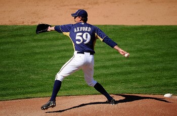 PHOENIX, AZ - MARCH 10:  John Axford #59 of the Milwaukee Brewers pitches against the Colorado Rockies during spring training baseball game at Maryvale Baseball Park on March 10, 2011 in Phoenix, Arizona.  (Photo by Kevork Djansezian/Getty Images)