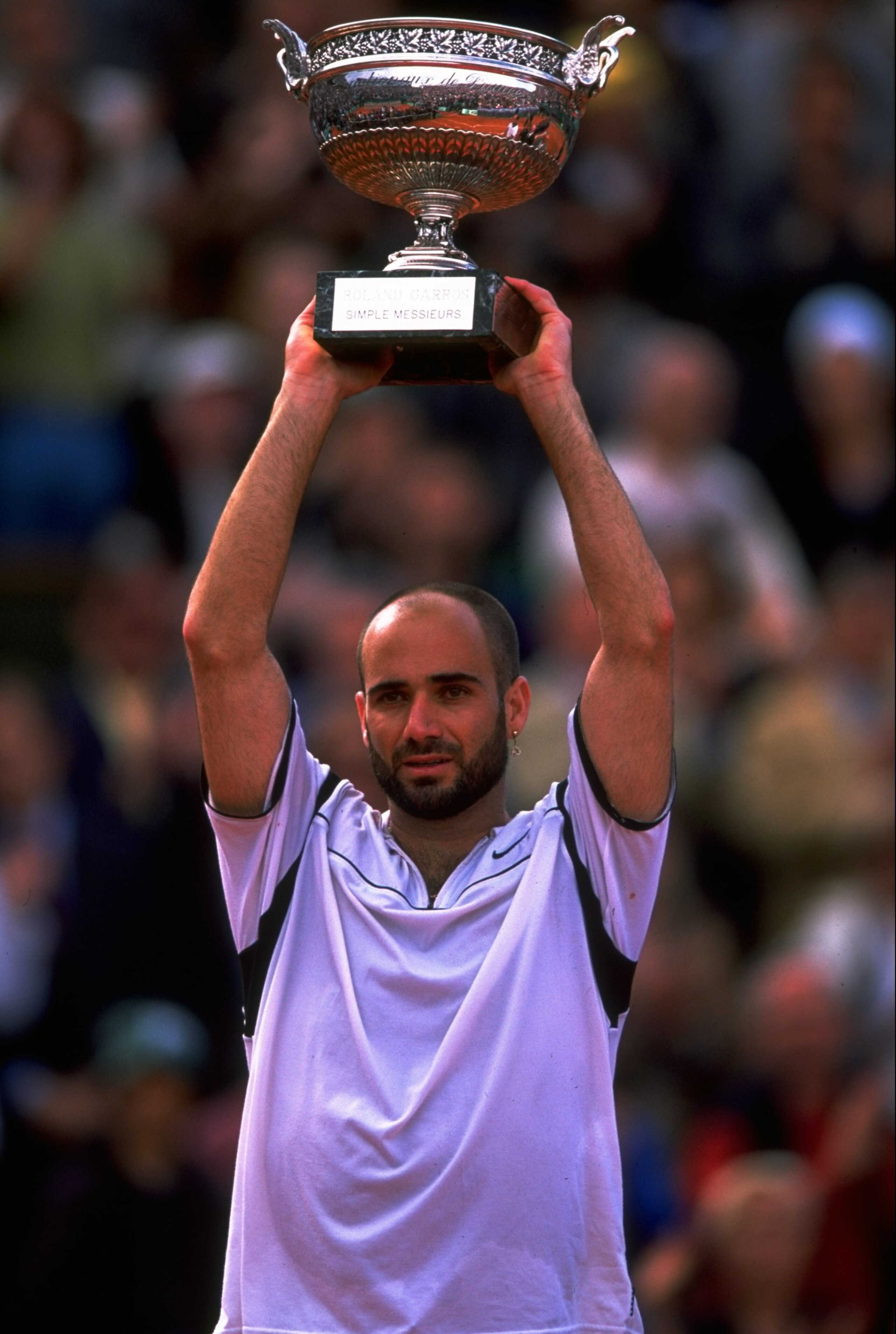 6 Jun 1999:  Andre Agassi of the United States celebrates victory with the trophy during the 1999 French Open Final match against Andrei Medvedev of the Ukraine played at Roland Garros in Paris, France.  The match finished in an emotional victory for Andr