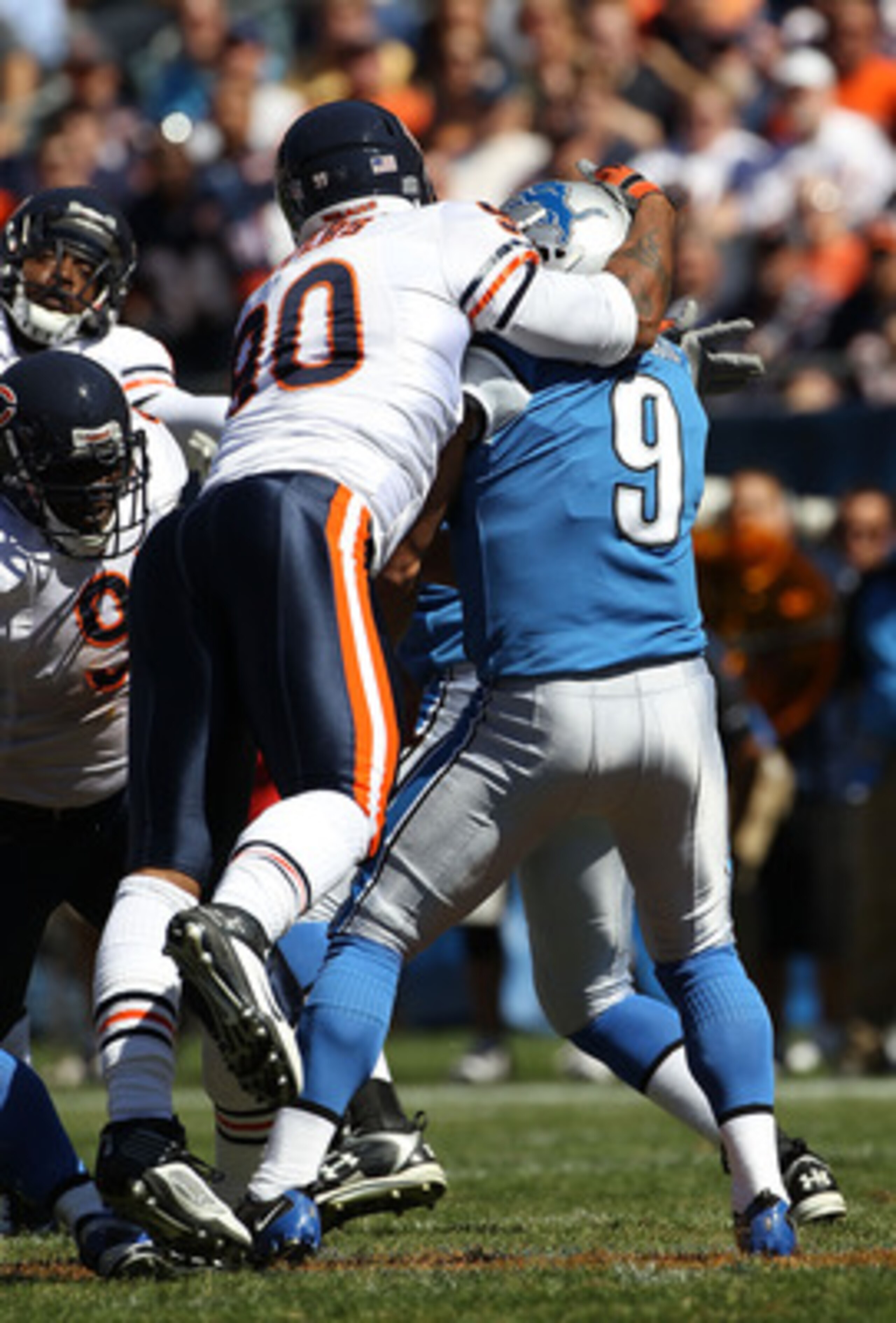 CHICAGO - SEPTEMBER 12: Julius Peppers #90 of the Chicago Bears hits Matthew Stafford #9 of the Detroit Lions in the head earning a penalty during the NFL season opening game at Soldier Field on September 12, 2010 in Chicago, Illinois. The Bears defeated