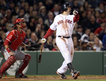 BOSTON, MA - MAY 02:  Adrian Gonzalez #28 of the Boston Red Sox hits a 2RBI double in the seventh inning as Jeff Mathis #5 of the Los Angeles Angels defends on May 2, 2011 at Fenway Park in Boston, Massachusetts.  (Photo by Elsa/Getty Images)