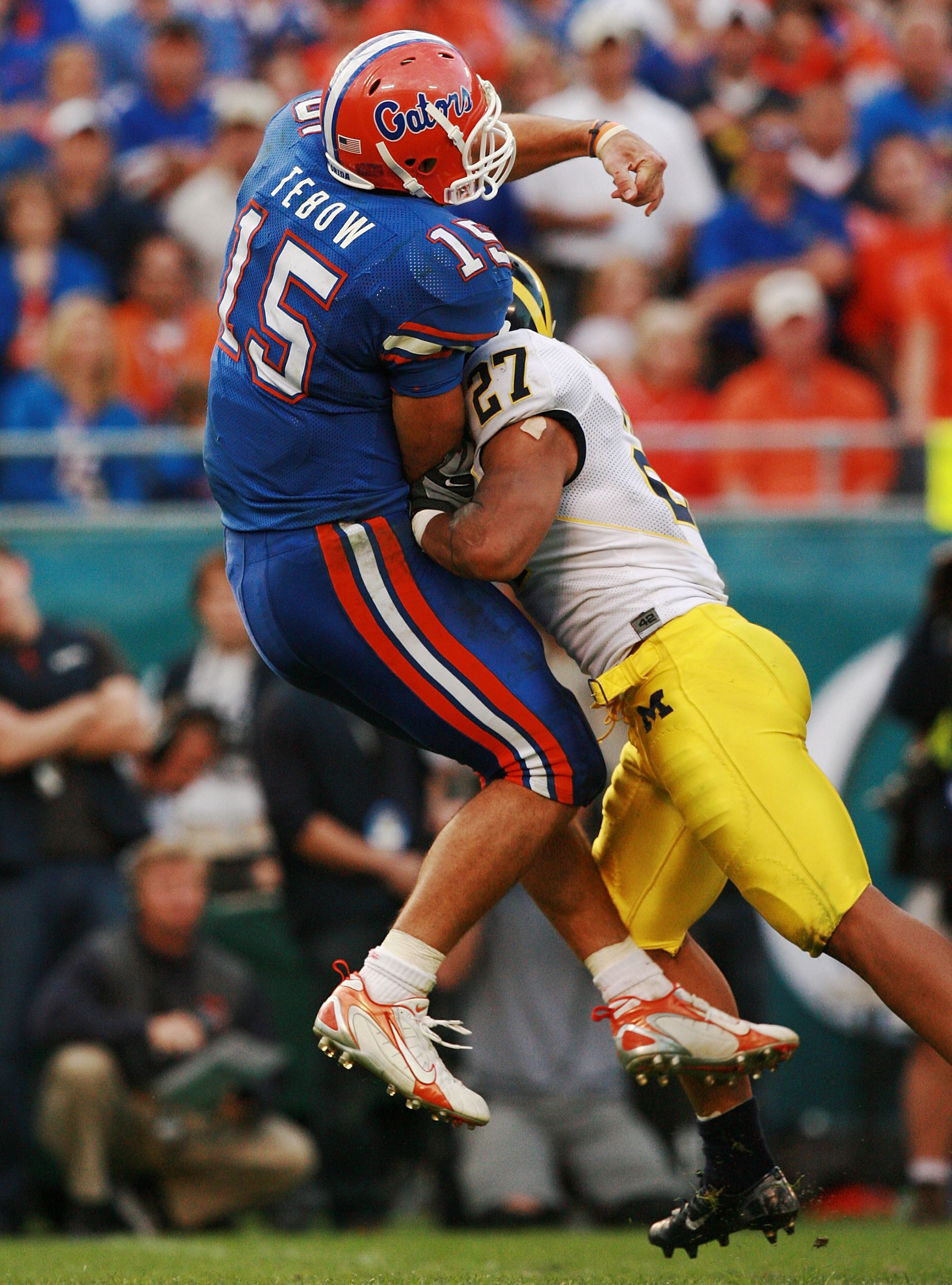 ORLANDO, FL - JANUARY 01:  Quarterback Tim Tebow #15 of the Florida Gators is hit by safety Brandon Harrison #27 of the Michigan Wolverines after throwing an incomplete pass to end his team's last offensive series in the Capital One Bowl at Florida Citrus