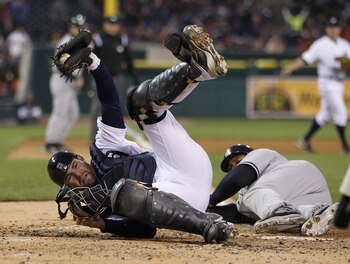 DETROIT, MI - MAY 03: Alex Avila #13 of the Detroit Tigers holds up the ball after blocking the plate and getting a out on a sliding Andruw Jones #18 of the New York Yankees at Comerica Park on May 3, 2011 in Detroit, Michigan. (Photo by Gregory Shamus/Ge