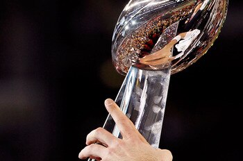 ARLINGTON, TX - FEBRUARY 06:  Quarterback Aaron Rodgers #12 of the Green Bay Packers holds up the VInce Lombardi trophy after the Packers won 31-25 against the Pittsburgh Steelers during Super Bowl XLV at Cowboys Stadium on February 6, 2011 in Arlington,