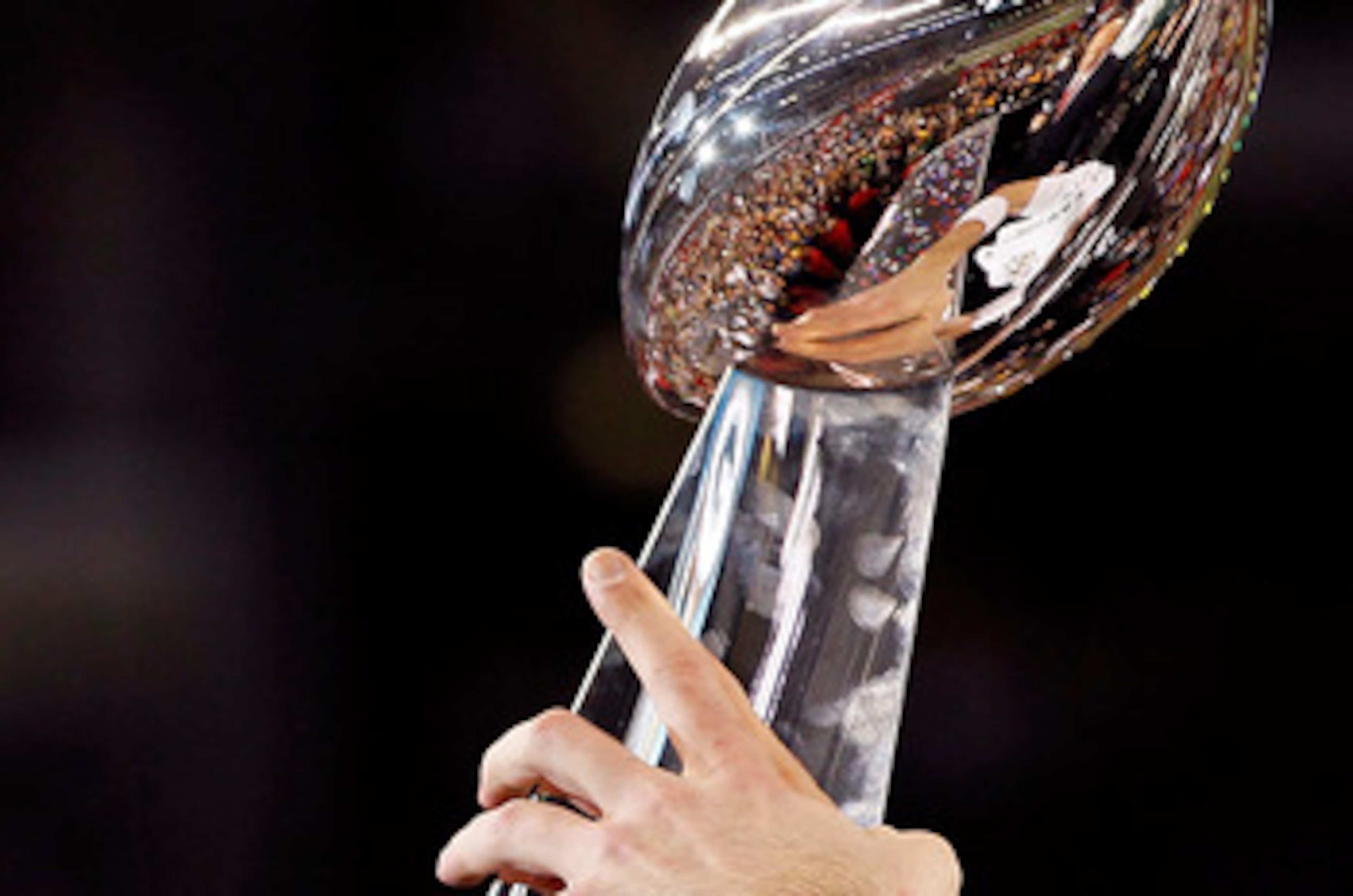 ARLINGTON, TX - FEBRUARY 06:  Quarterback Aaron Rodgers #12 of the Green Bay Packers holds up the VInce Lombardi trophy after the Packers won 31-25 against the Pittsburgh Steelers during Super Bowl XLV at Cowboys Stadium on February 6, 2011 in Arlington,