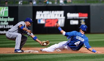 SURPRISE, AZ - MARCH 12:  Rafael Furcal #15 of the the Los Angeles Dodgers reaches to tag out Alex Gordon #4 of the Kansas City Royals during steak attempt in the second inning of  the spring training baseball game at Surprise Stadium on March 12, 2011 in
