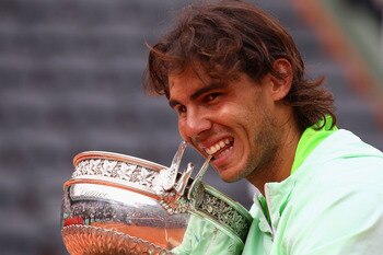 PARIS - JUNE 06:  Rafael Nadal of Spain celebrates with the trophy after winning the men's singles final match between Rafael Nadal of Spain and Robin Soderling of Sweden on day fifteen of the French Open at Roland Garros on June 6, 2010 in Paris, France.