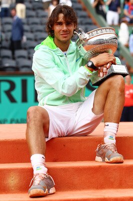 PARIS - JUNE 06:  Rafael Nadal of Spain celebrates with the trophy after winning the men's singles final match between Rafael Nadal of Spain and Robin Soderling of Sweden on day fifteen of the French Open at Roland Garros on June 6, 2010 in Paris, France.