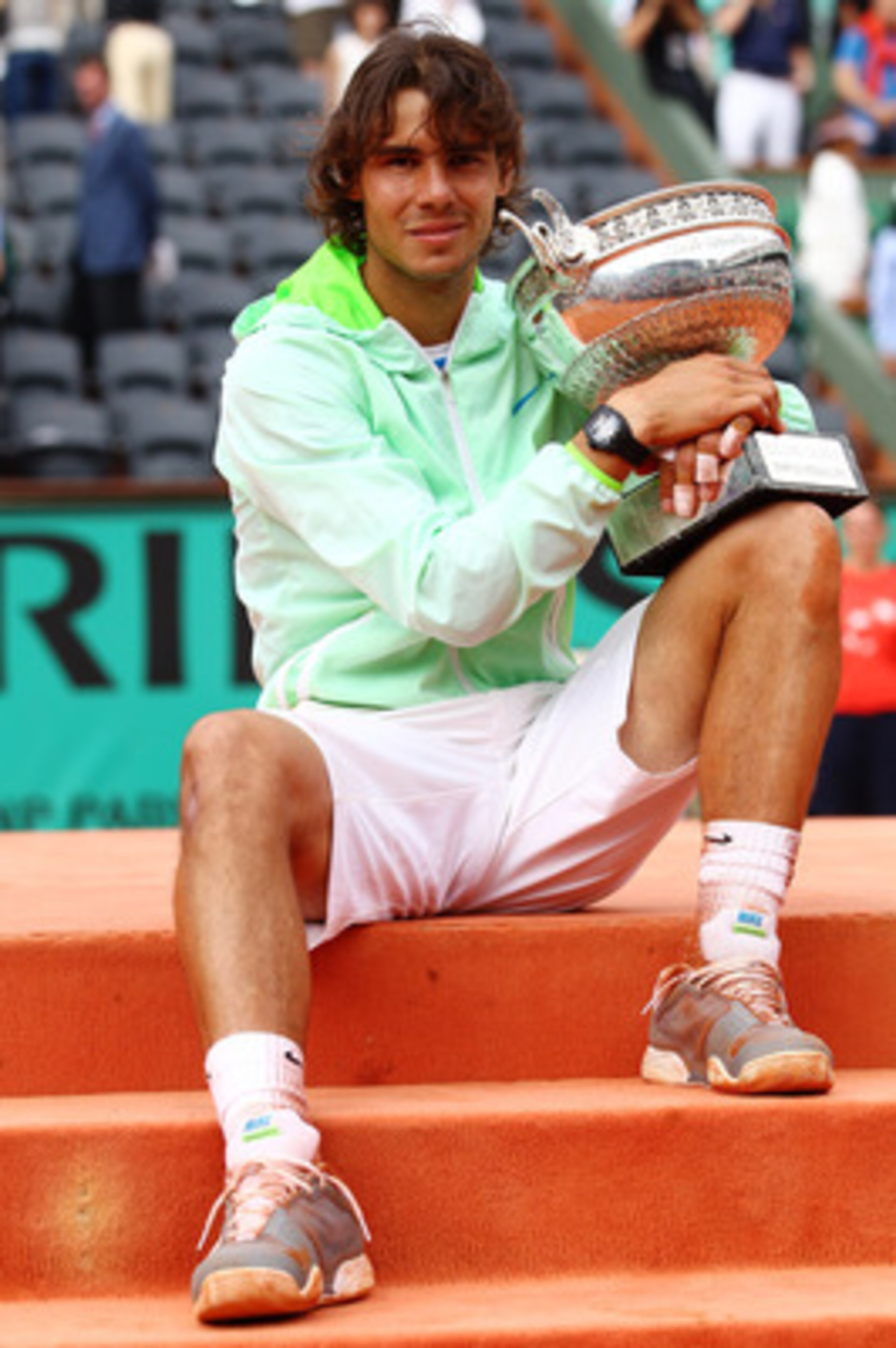 PARIS - JUNE 06: Rafael Nadal of Spain celebrates with the trophy after winning the men's singles final match between Rafael Nadal of Spain and Robin Soderling of Sweden on day fifteen of the French Open at Roland Garros on June 6, 2010 in Paris, France. PARIS - JUNE 06: Rafael Nadal of Spain celebrates with the trophy after winning the men's singles final match between Rafael Nadal of Spain and Robin Soderling of Sweden on day fifteen of the French Open at Roland Garros on June 6, 2010 in Paris, France.
