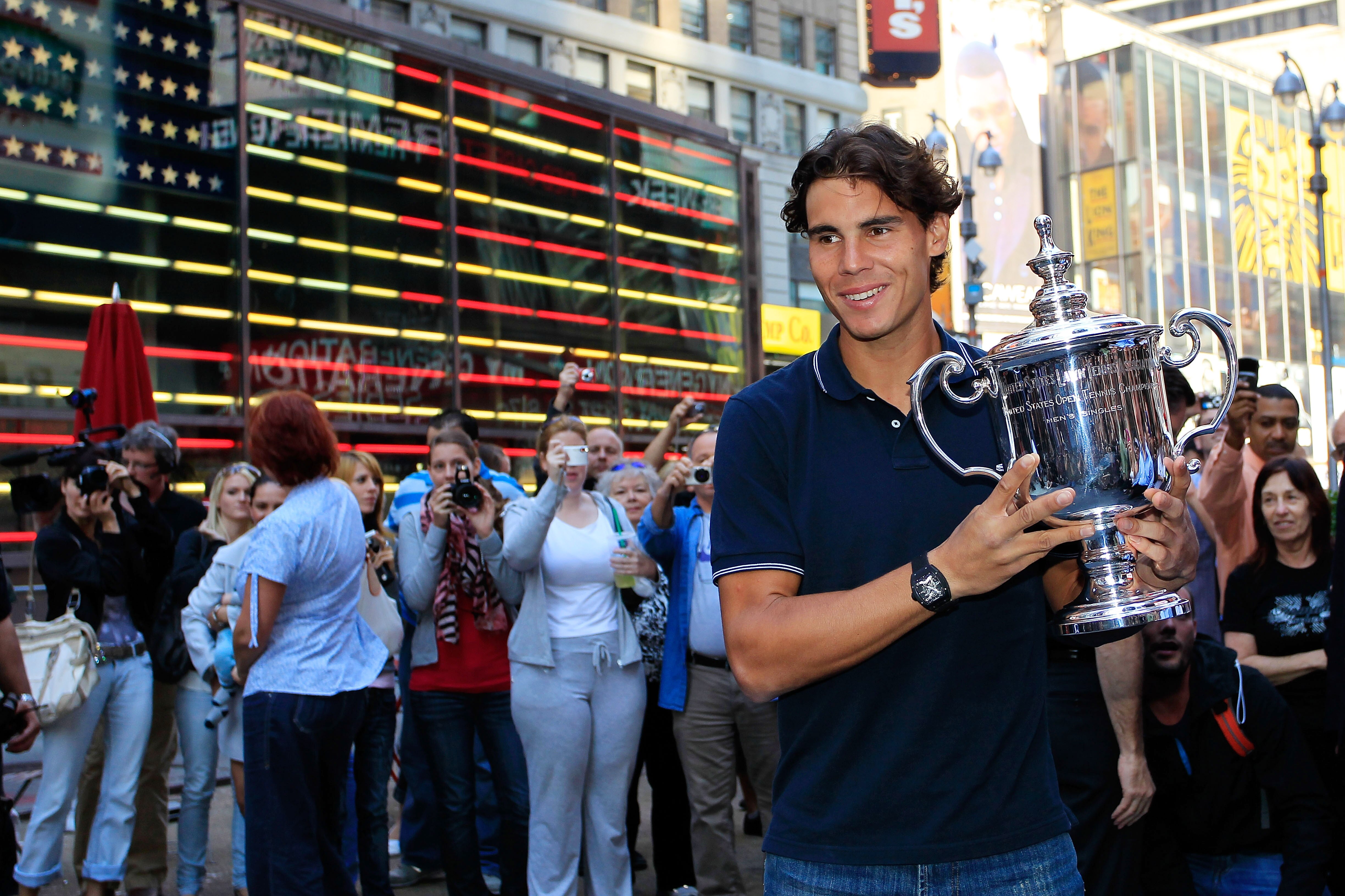 NEW YORK - SEPTEMBER 14:  Rafael Nadal of Spain, the 2010 U.S. Open Champion poses with the trophy in Times Square on September 14, 2010 in New York City  (Photo by Chris Trotman/Getty Images for ATP)