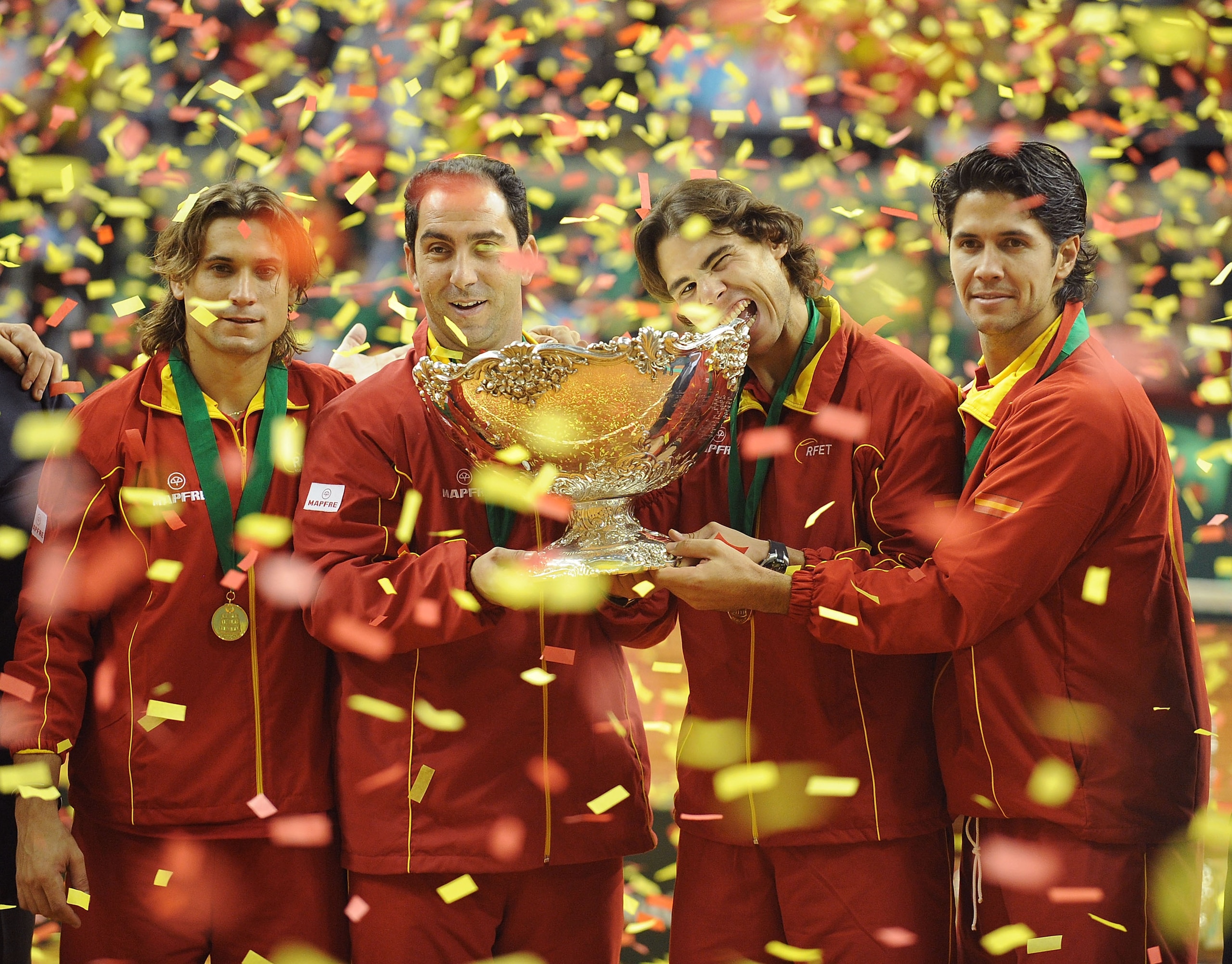 BARCELONA, SPAIN - DECEMBER 06:  Spanish players David Ferrer (L) team captain Albert Costa (C) Rafael Nadal and Fernando Verdasco (R) celebrate with the Davis Cup trophy at the end of the final match between Spain and Czech Republic at the Palau Sant Jor