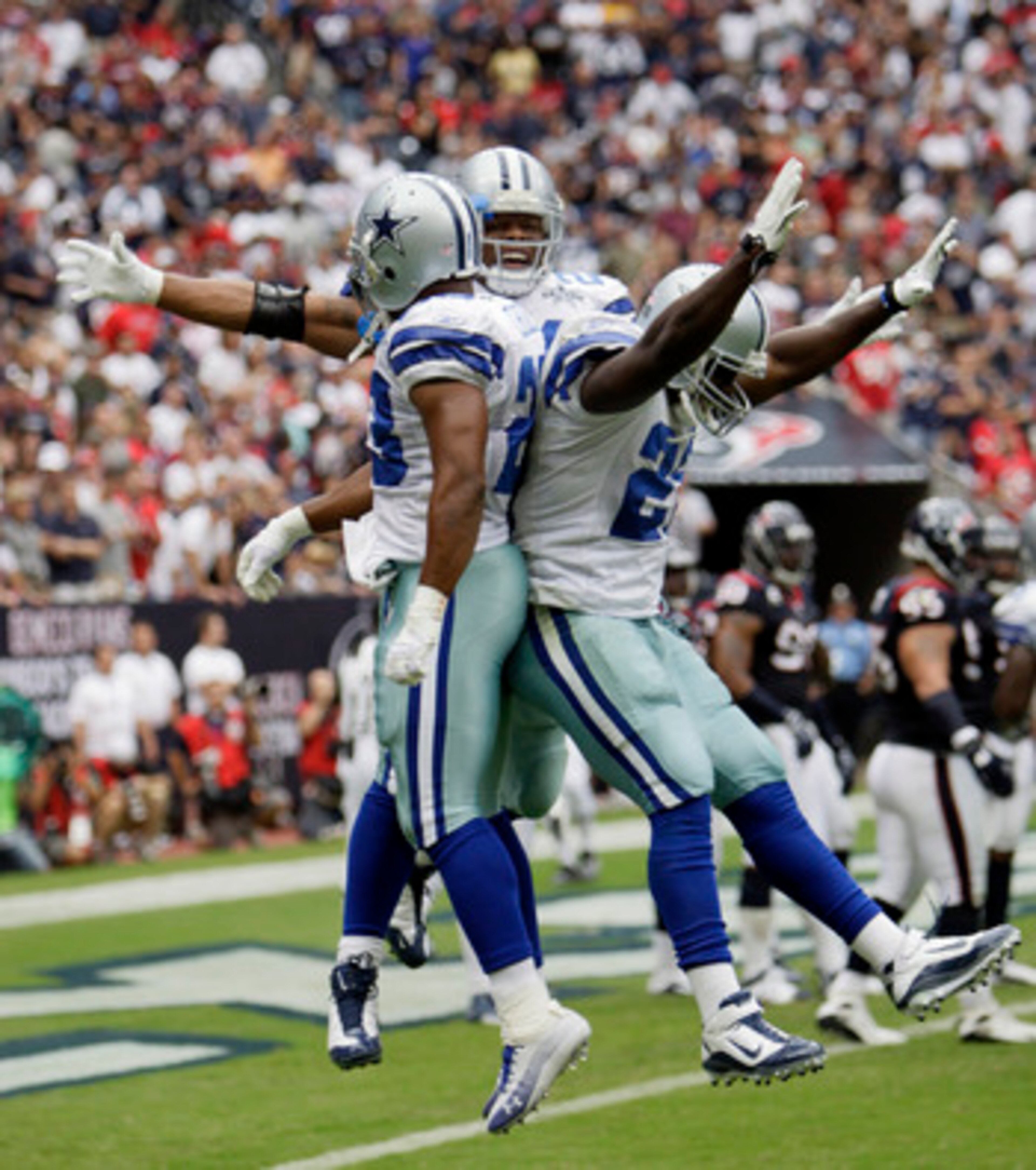 HOUSTON - SEPTEMBER 26:  Running back Marion Barber #24, center, of the Dallas Cowboys celebrates with Tashard Choice #23, left, and Felix Jones #28, right after scoring in the second quarter against the Houston Texans at Reliant Stadium on September 26, 