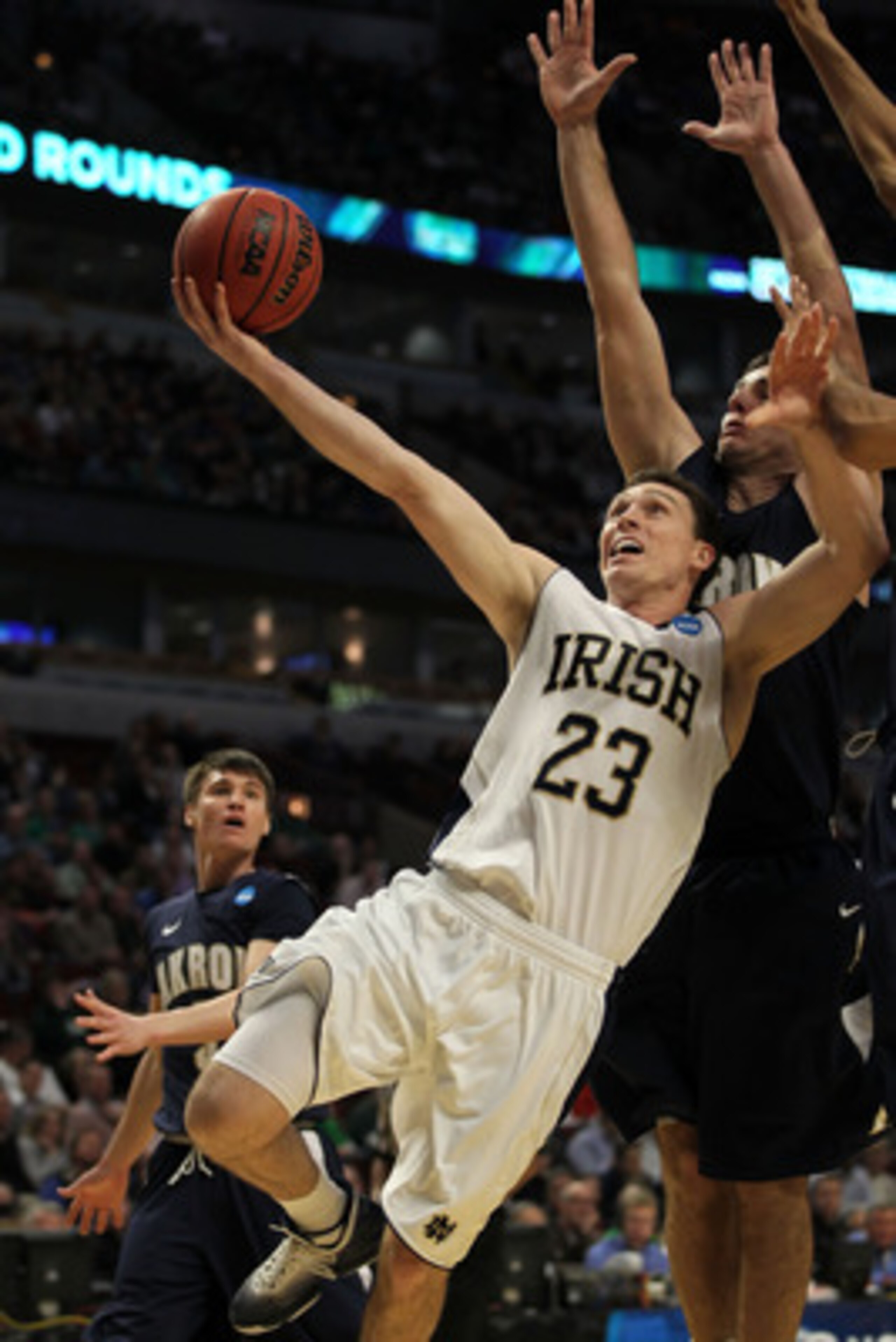 CHICAGO, IL - MARCH 18: Ben Hansbrough #23 of the Notre Dame Fighting Irish shoots against Nikola Cvetinovic #13 of the Akron Zips in the first half during the second round of the 2011 NCAA men's basketball tournament at the United Center on March 18, 20 CHICAGO, IL - MARCH 18: Ben Hansbrough #23 of the Notre Dame Fighting Irish shoots against Nikola Cvetinovic #13 of the Akron Zips in the first half during the second round of the 2011 NCAA men's basketball tournament at the United Center on March 18, 20