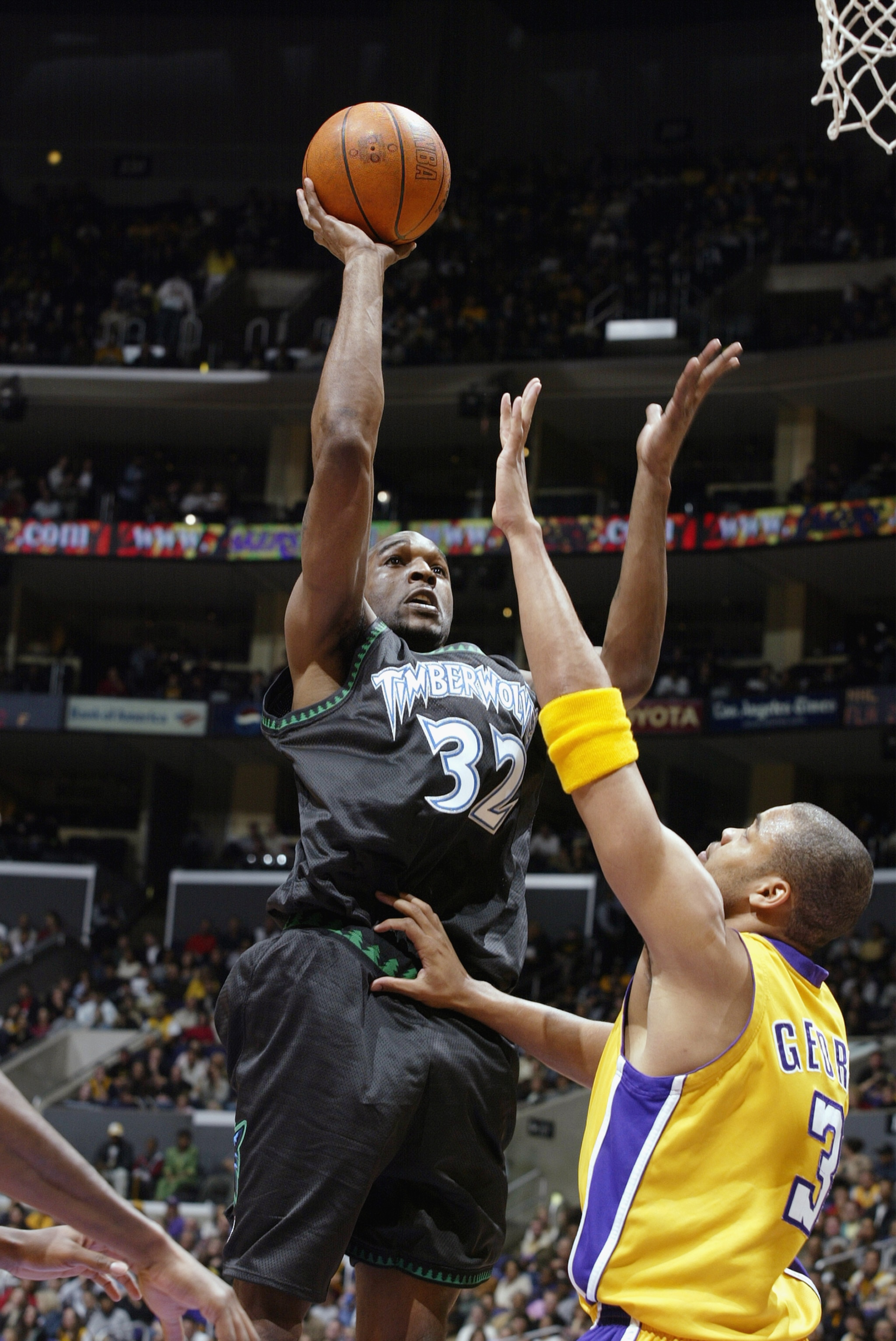 LOS ANGELES - MARCH 7:  Joe Smith #32 of the Minnesota Timberwolves puts a shot up over Devean George #3 of the Los Angeles Lakers during the NBA game at Staples Center on March 7, 2003 in Los Angeles, California.  The Lakers won 106-96.  NOTE TO USER: Us