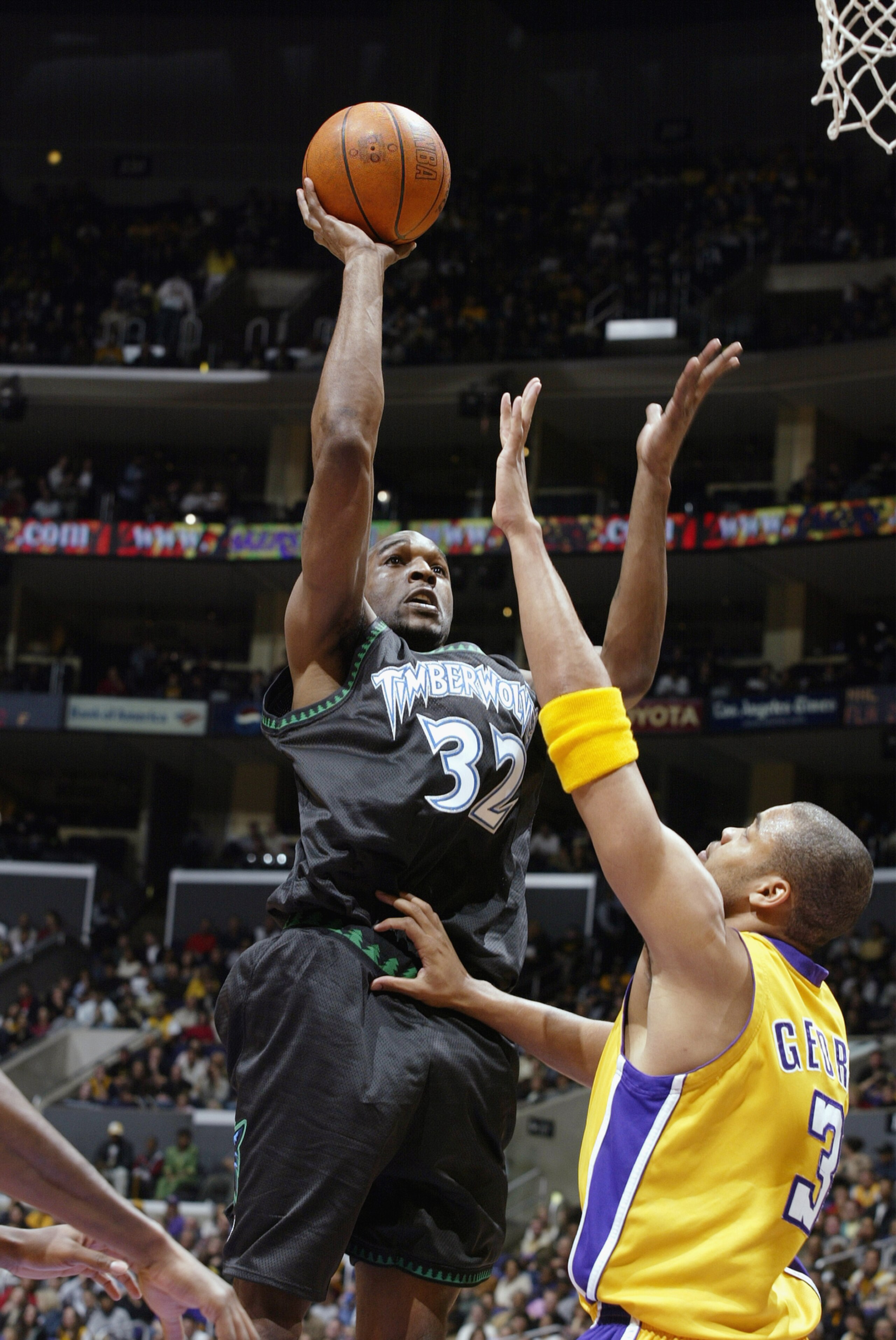 LOS ANGELES - MARCH 7:  Joe Smith #32 of the Minnesota Timberwolves puts a shot up over Devean George #3 of the Los Angeles Lakers during the NBA game at Staples Center on March 7, 2003 in Los Angeles, California.  The Lakers won 106-96.  NOTE TO USER: Us