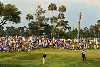 PONTE VEDRA BEACH, FL - MAY 12:  Tiger Woods chips to the second hole green as caddie Steve Williams looks on during the first round of THE PLAYERS Championship held at THE PLAYERS Stadium course at TPC Sawgrass on May 12, 2011 in Ponte Vedra Beach, Flori