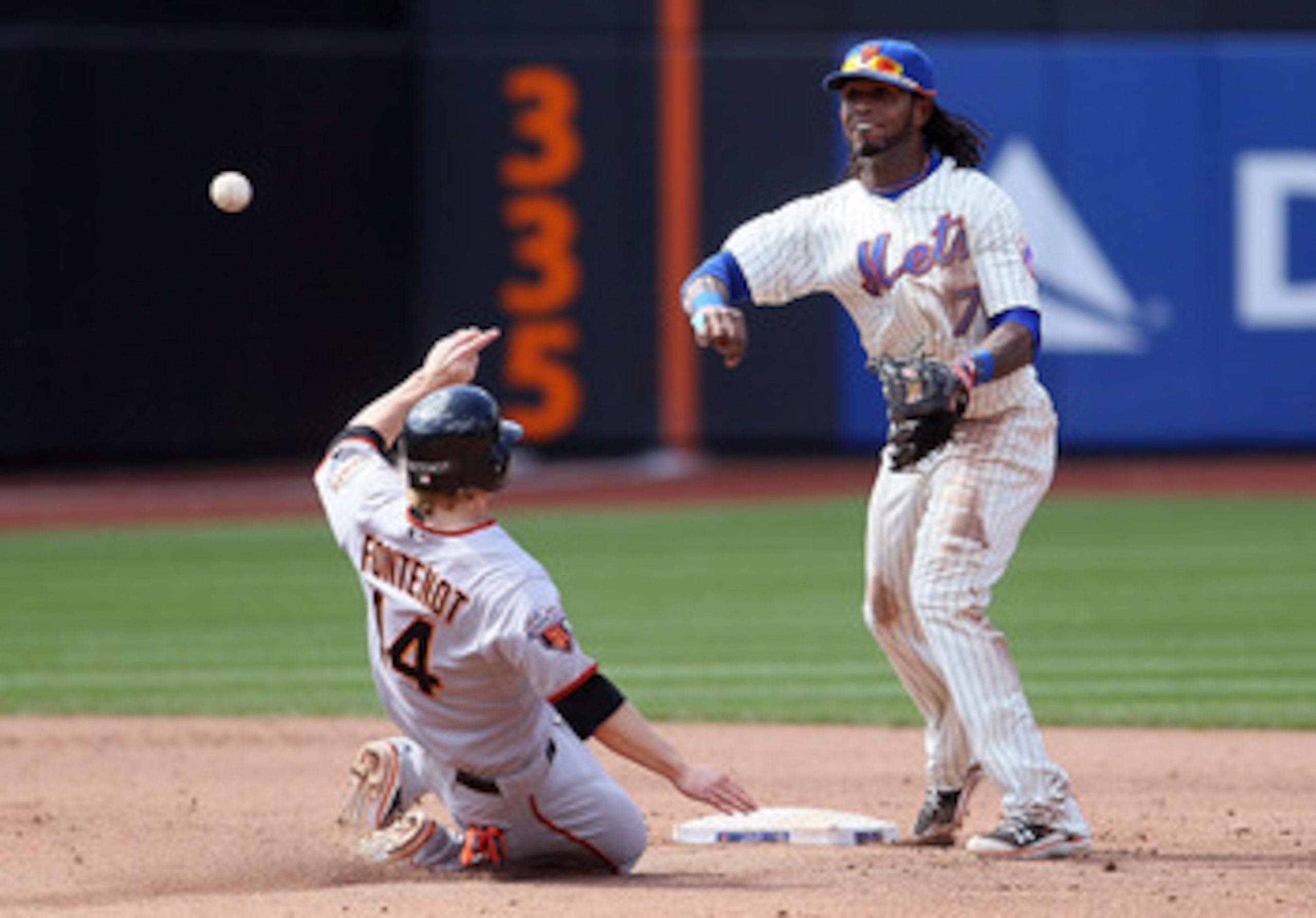 NEW YORK, NY - MAY 05:  Jose Reyes #7 of the New York Mets throws to first to complete a sixth inning double play after forcing out Mike Fontenot #14 of the San Francisco Giants on May 5, 2011 at Citi Field in the Flushing neighborhood of the Queens borou
