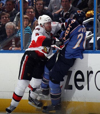 ATLANTA, GA - MARCH 27: Chris Phillips #4 of the Ottawa Senators hits Radek Dvorak #20 of the Atlanta Thrashers at the Philips Arena on March 27, 2011 in Atlanta, Georgia.  (Photo by Bruce Bennett/Getty Images)