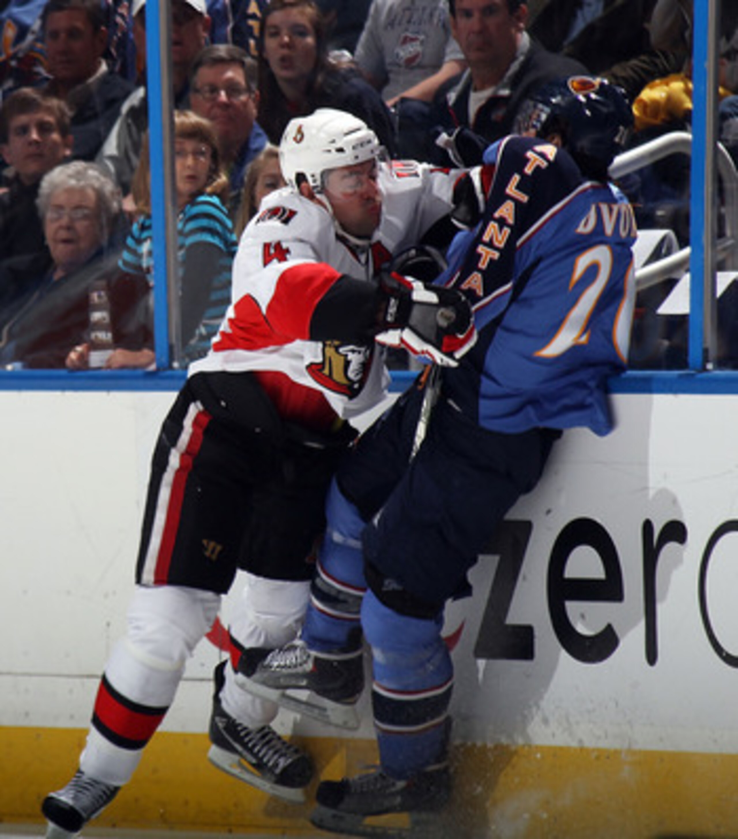 ATLANTA, GA - MARCH 27: Chris Phillips #4 of the Ottawa Senators hits Radek Dvorak #20 of the Atlanta Thrashers at the Philips Arena on March 27, 2011 in Atlanta, Georgia.  (Photo by Bruce Bennett/Getty Images)