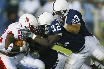 ORCHARD PARK, NY - SEPTEMBER 14:  Cory Ross #22 of Nebraska is stopped by Bryan Scott #32, Ryan Scott #83 and Derek Wake #94 of Penn State during their NCAA football game on September 14, 2002 at Beaver Stadium in State College, Pennsylvania.  Penn State