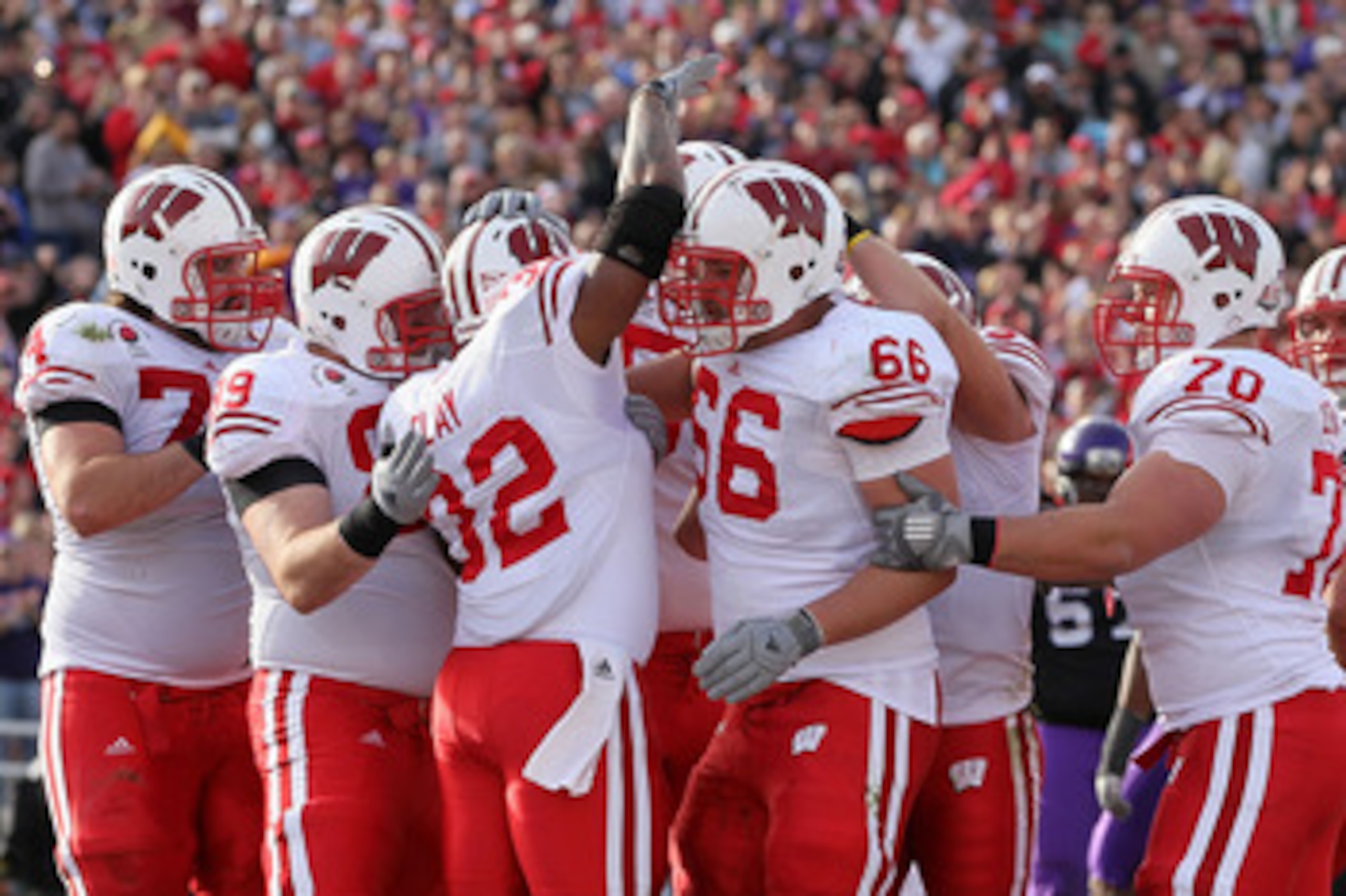 PASADENA, CA - JANUARY 01:  Running back John Clay #32 of the Wisconsin Badgers celebrates with teammates after scoring a touchdown in the first quarter against the TCU Horned Frogs during the 97th Rose Bowl game on January 1, 2011 in Pasadena, California