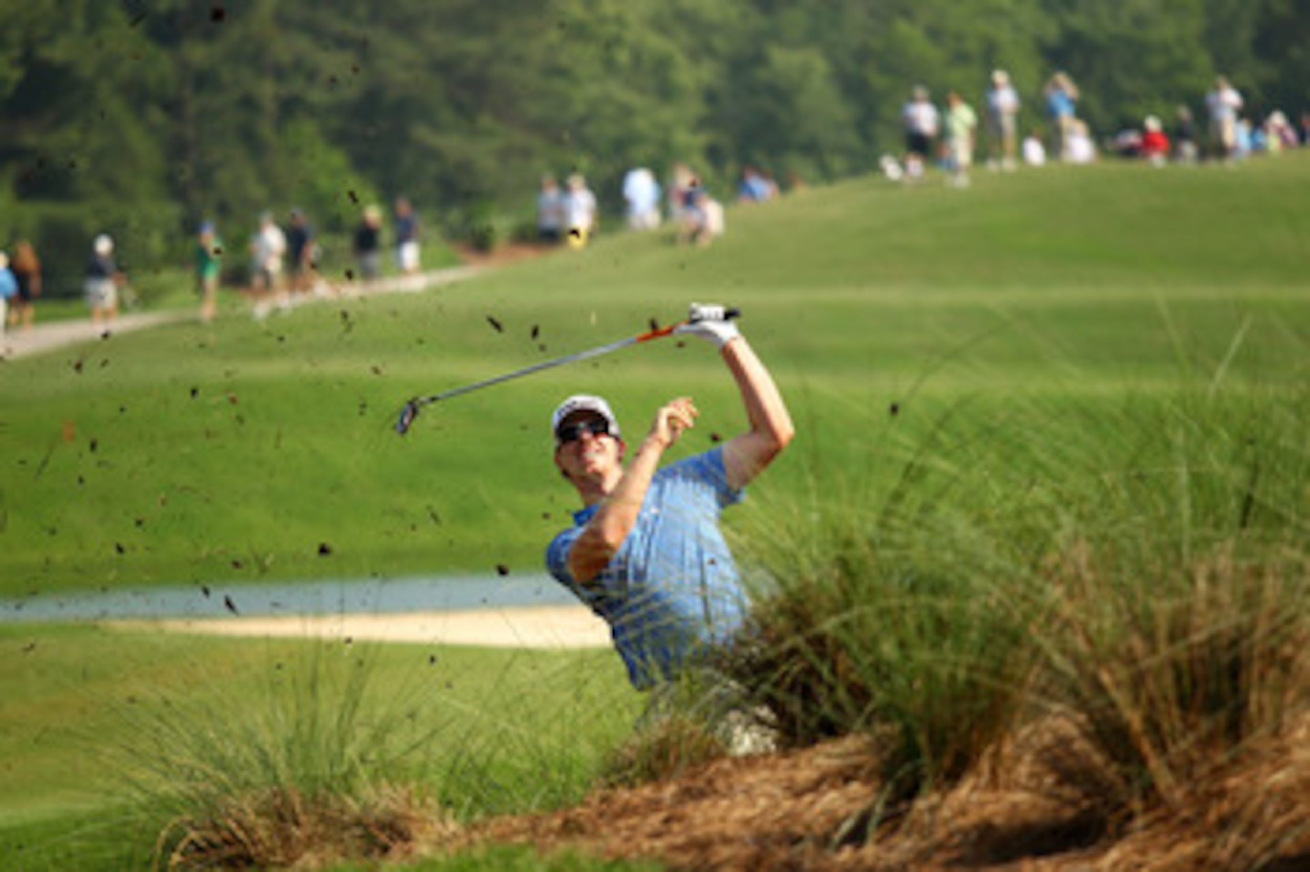 PONTE VEDRA BEACH, FL - MAY 06:  Hunter Mahan plays a shot from the rough on the 12th hole during the first round of THE PLAYERS Championship held at THE PLAYERS Stadium course at TPC Sawgrass on May 6, 2010 in Ponte Vedra Beach, Florida.  (Photo by Richa