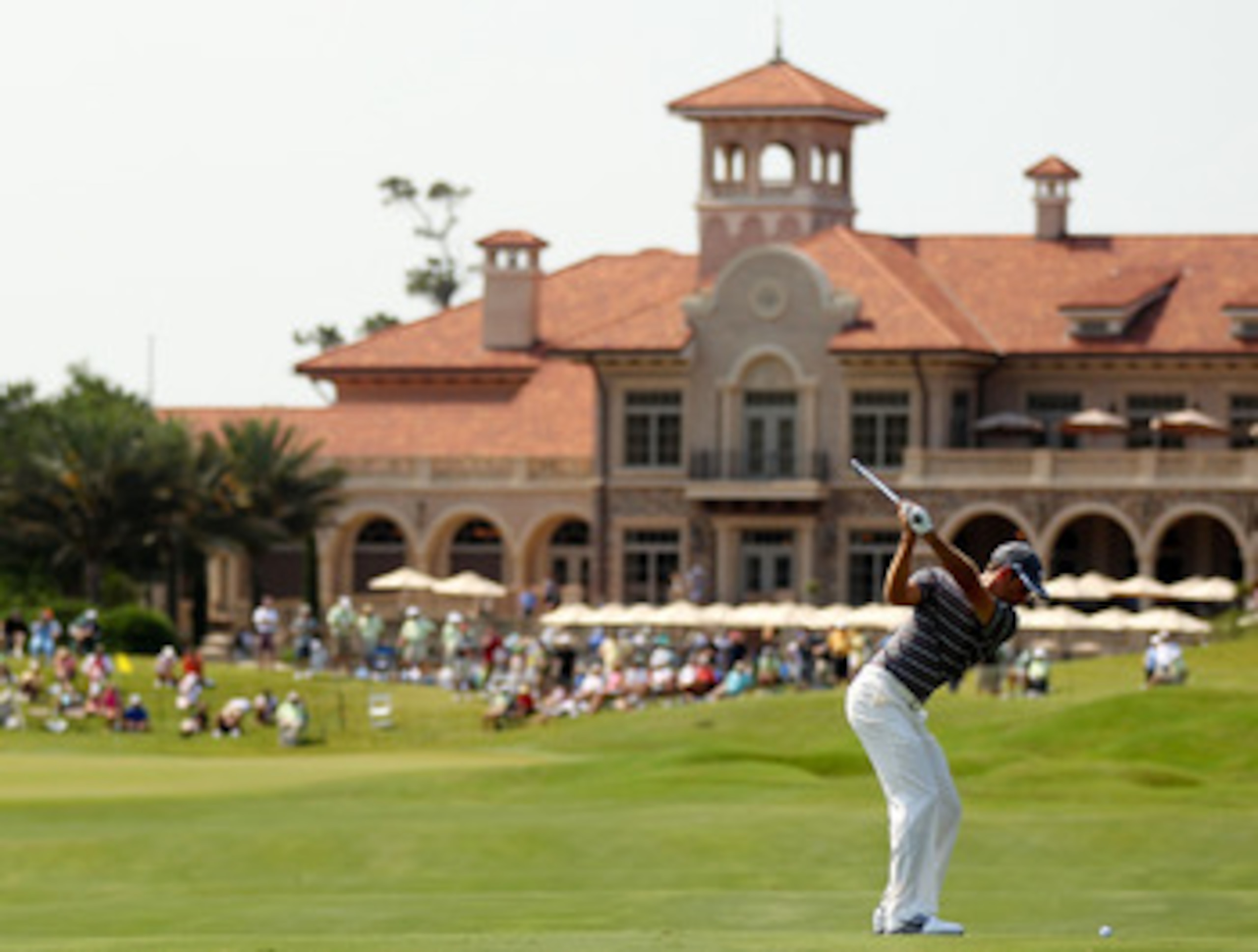 PONTE VEDRA BEACH, FL - MAY 12:  Charl Schwartzel of South Africa hits his approach shot on the 18th hole during the first round of THE PLAYERS Championship held at THE PLAYERS Stadium course at TPC Sawgrass on May 12, 2011 in Ponte Vedra Beach, Florida.