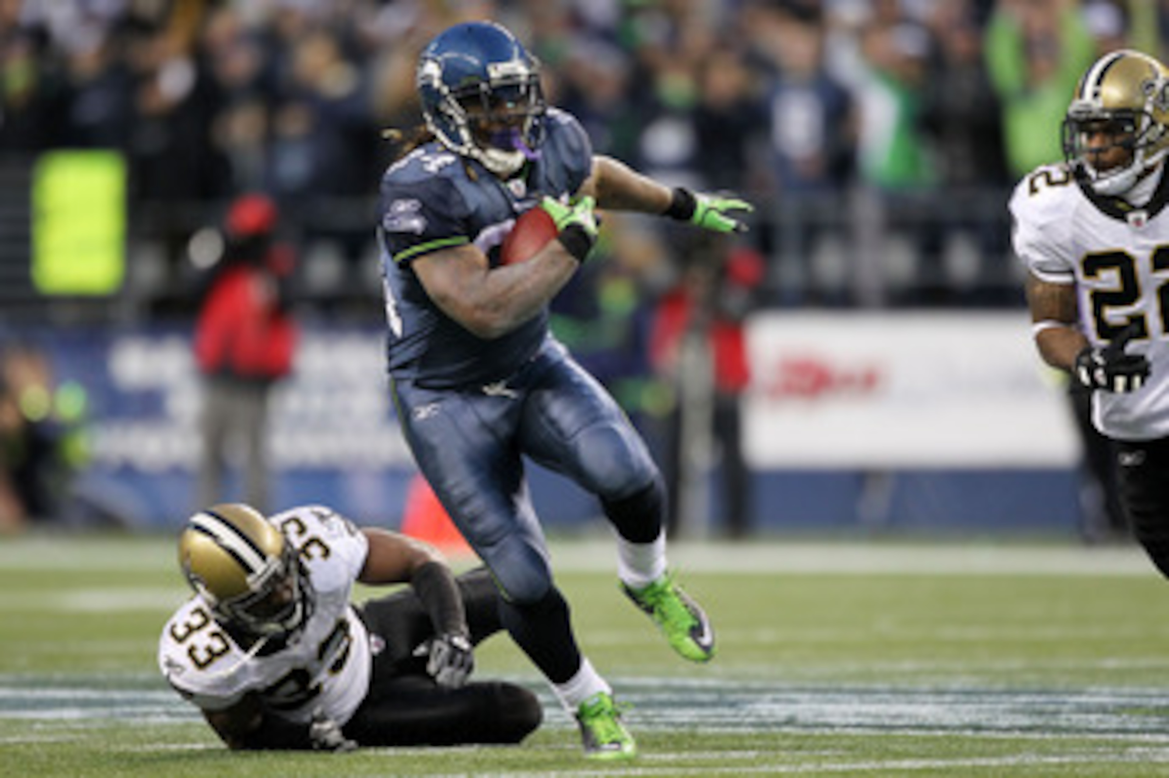 SEATTLE, WA - JANUARY 08:  Marshawn Lynch #24 of the Seattle Seahawks runs down field against Jabari Greer #33 of the New Orleans Saints during the 2011 NFC wild-card playoff game at Qwest Field on January 8, 2011 in Seattle, Washington.  (Photo by Otto G
