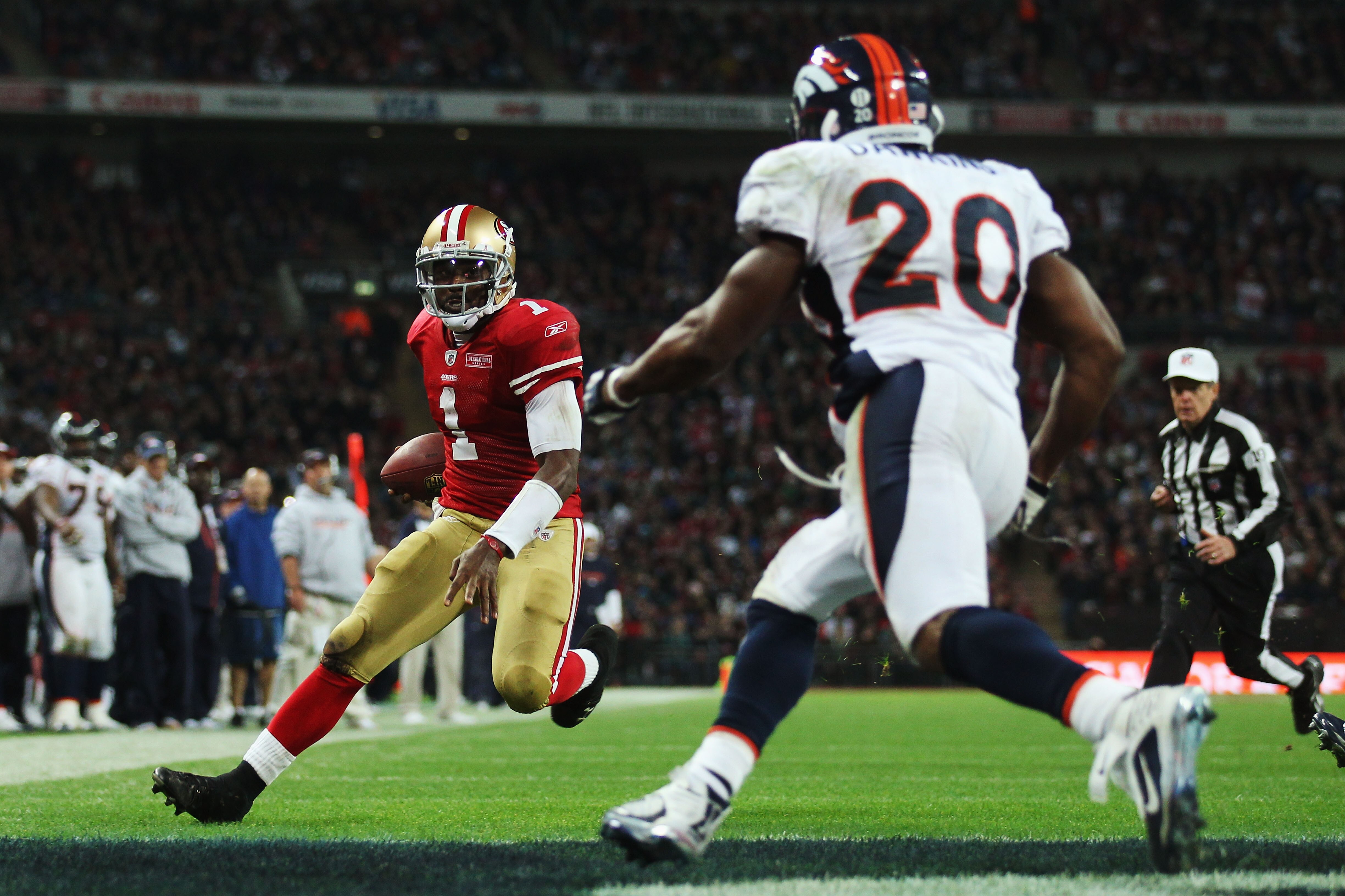 LONDON, ENGLAND - OCTOBER 31:  Troy Smith #1 of San Francisco 49ers is faced by Brian Dawkins #20 of Denver Broncos as he scores their first touchdown during the NFL International Series match between Denver Broncos and San Francisco 49ers at Wembley Stad
