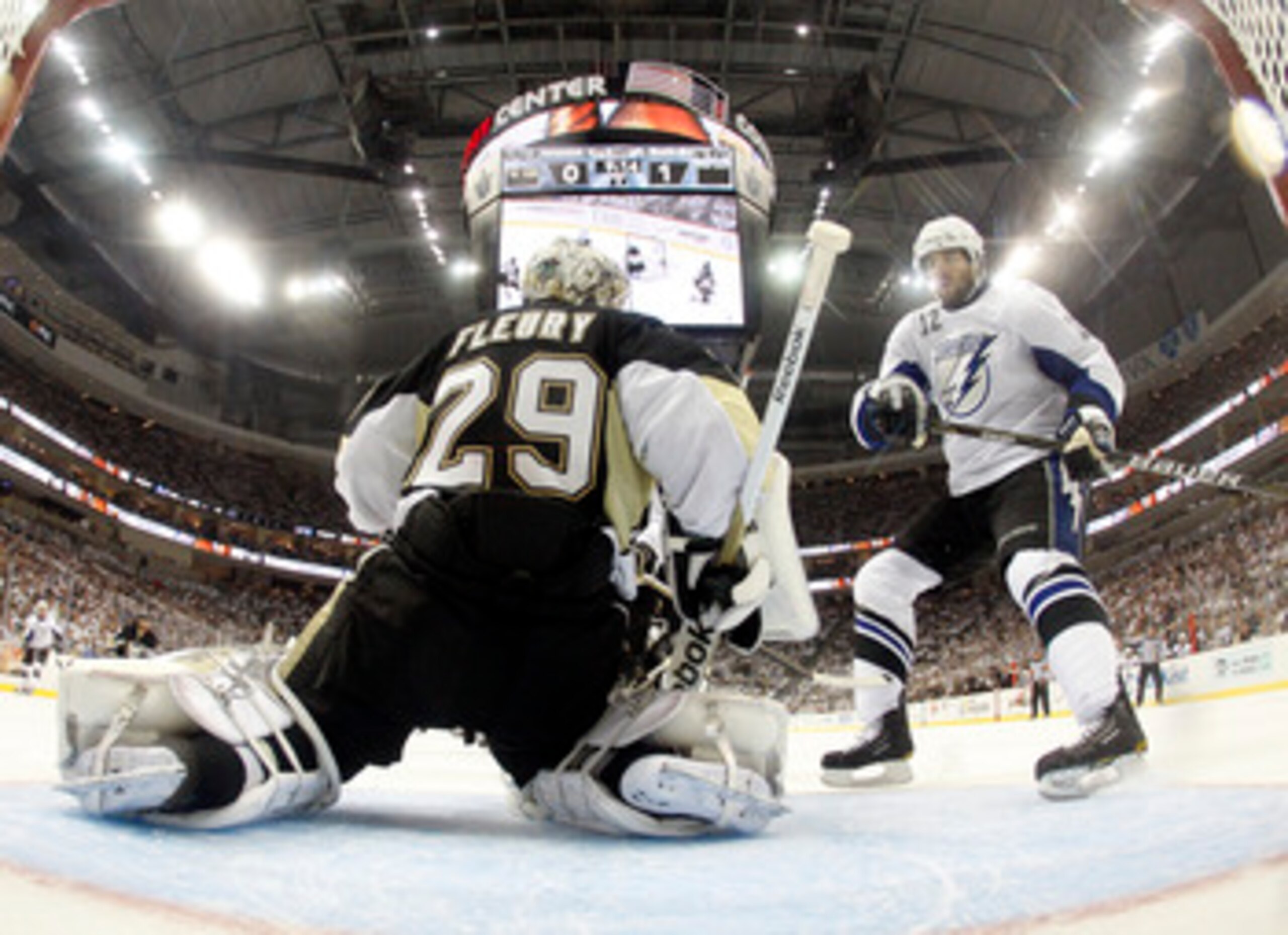 PITTSBURGH, PA - APRIL 27:  Marc-Andre Fleury #29 of the Pittsburgh Penguins protects the net against Simon Gagne #12 of the Tampa Bay Lightning in Game Seven of the Eastern Conference Quarterfinals during the 2011 NHL Stanley Cup Playoffs at Consol Energ