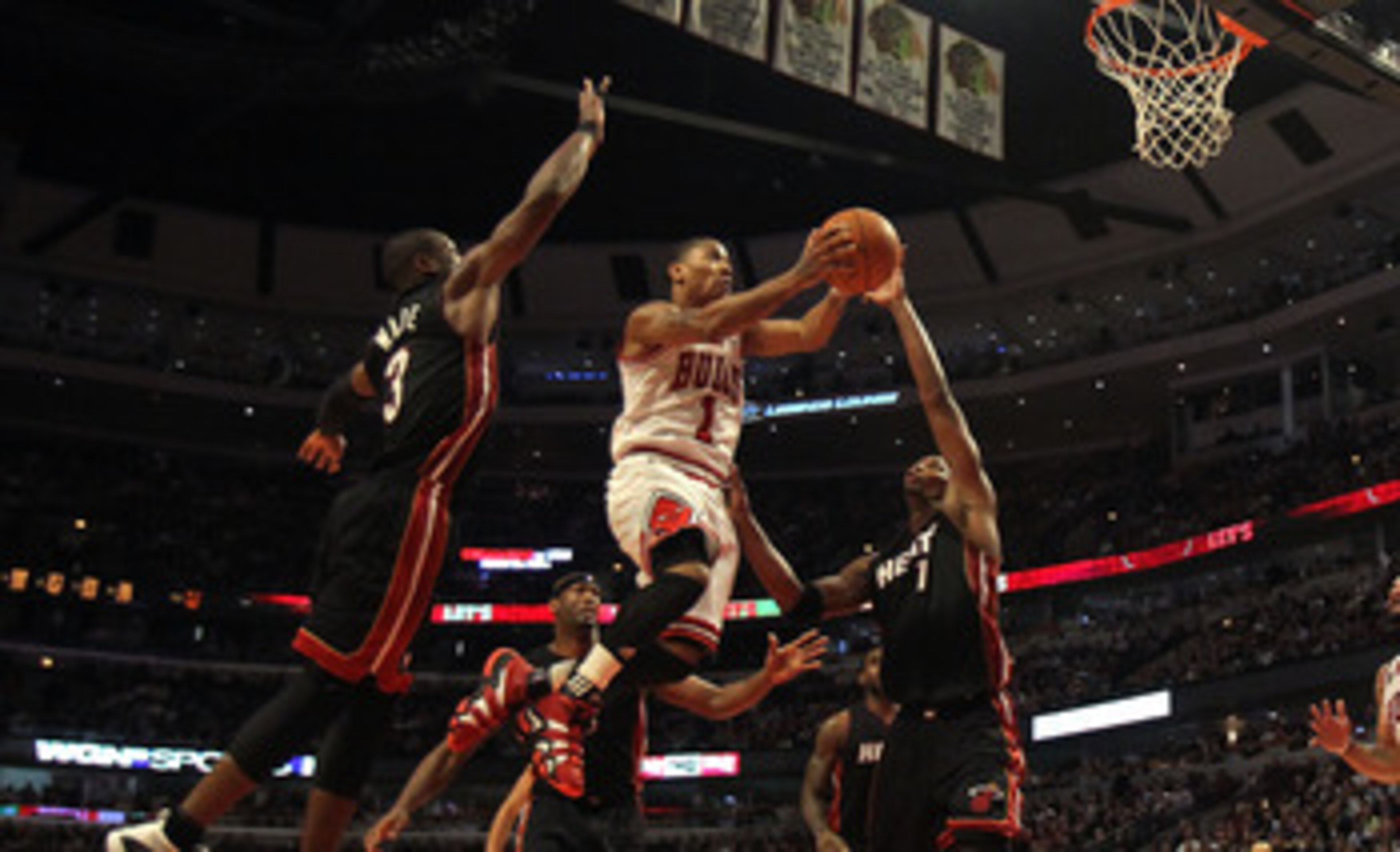 CHICAGO, IL - FEBRUARY 24: Derrick Rose #1 of the Chicago Bulls puts up a shot between Dwyane Wade #3 and Chris Bosh #1 of the Miami Heat at the United Center on February 24, 2011 in Chicago, Illinois. The Bulls defeated the Heat 93-89. NOTE TO USER: User