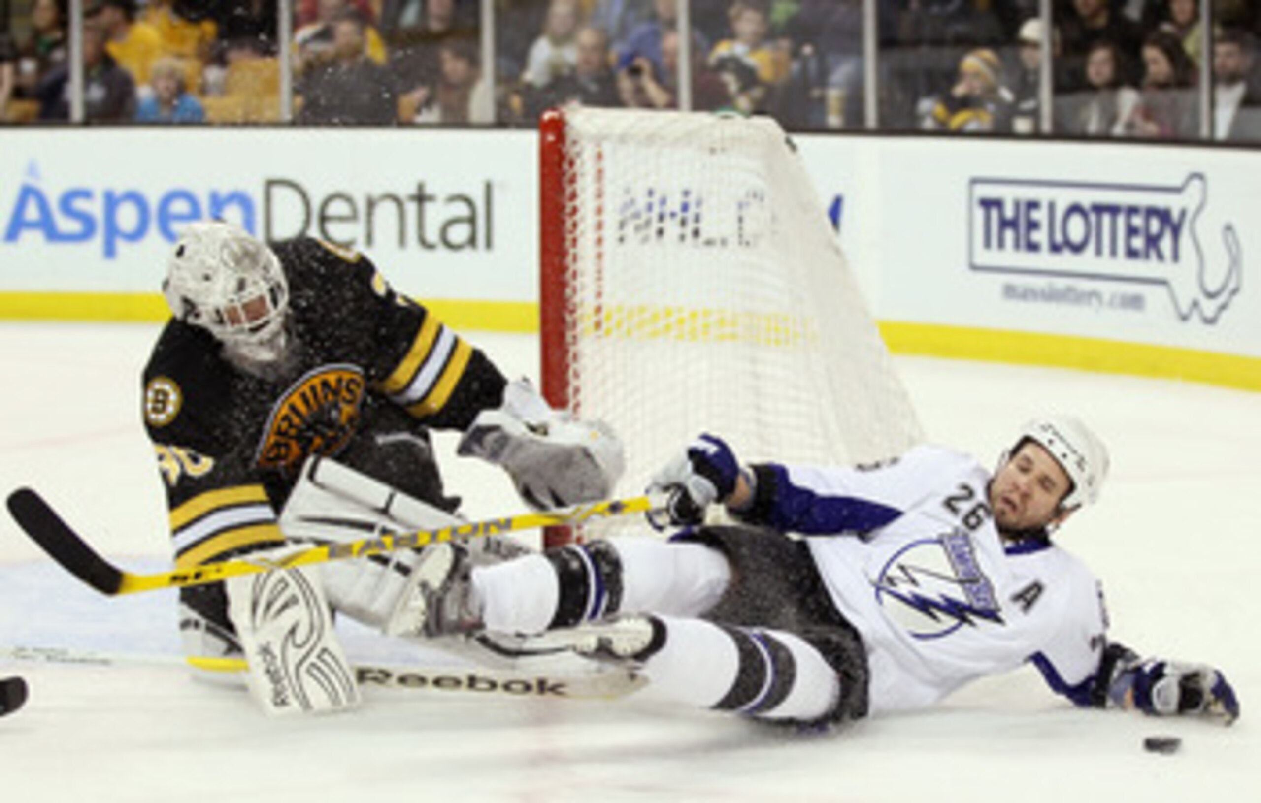 BOSTON, MA - MARCH 03:  Tim Thomas #30 of the Boston Bruins stops a shot as Martin St. Louis #26 of the Tampa Bay Lightning runs into him in the second period on March 3, 2011 at the TD Garden in Boston, Massachusetts.  (Photo by Elsa/Getty Images)