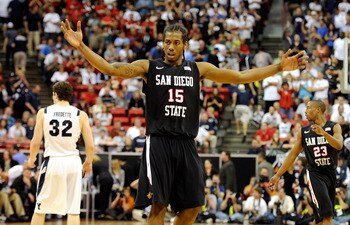 LAS VEGAS, NV - MARCH 12:  Kawhi Leonard #15 of the San Diego State Aztecs raises his arms in the last few seconds of the team's 72-54 victory over the Brigham Young University Cougars in the championship game of the Conoco Mountain West Conference Basket
