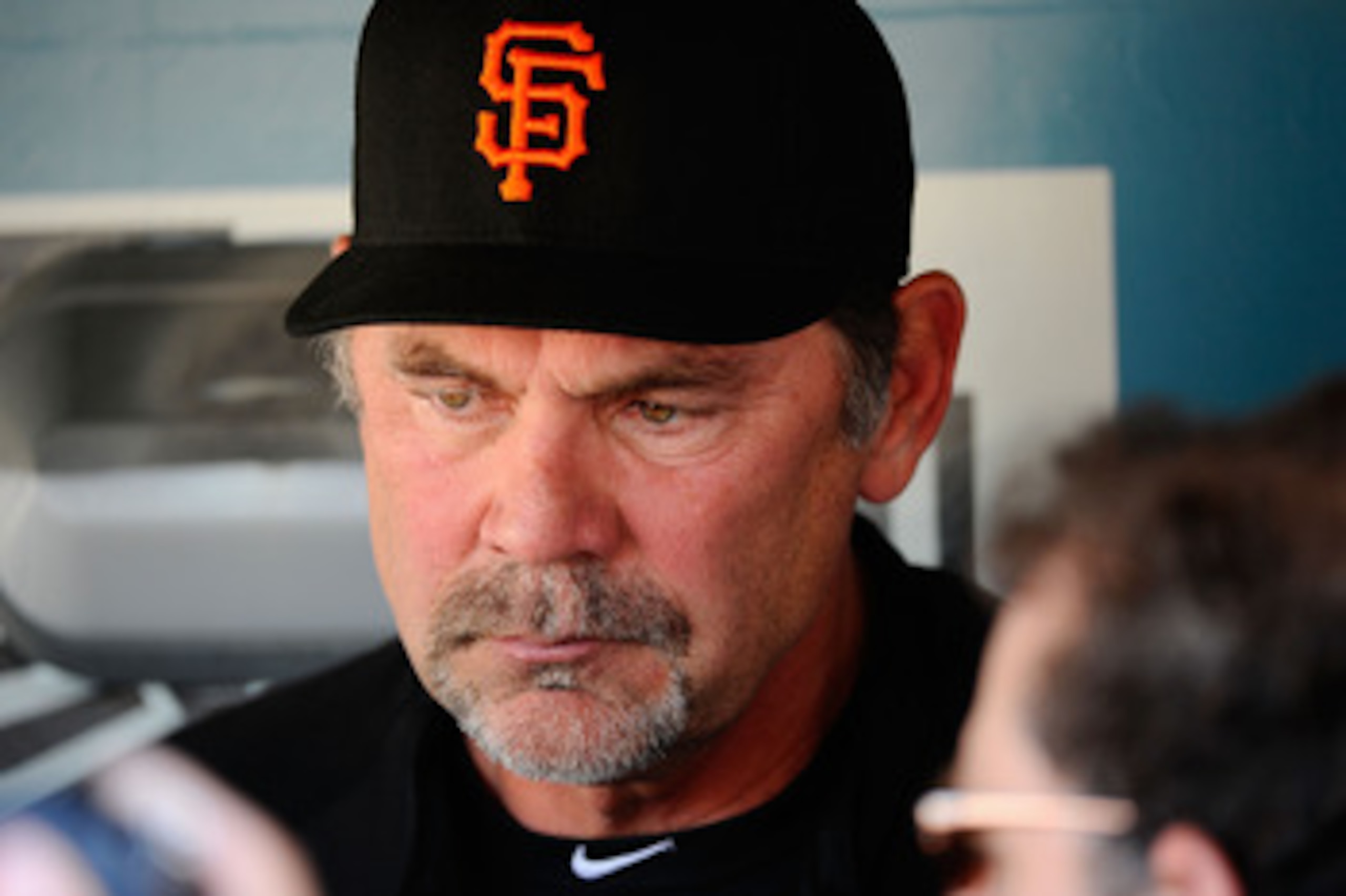 LOS ANGELES, CA - MARCH 31:  Bruce Bochy #15 of the San Francisco Giants speaks with members of the media in the dugout prior to playing the Los Angeles Dodgers on Opening Day at Dodger Stadium on March 31, 2011 in Los Angeles, California.  (Photo by Kevo