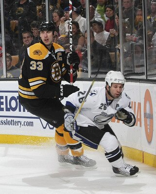 BOSTON - DECEMBER 02:  Zdeno Chara #33 of the Boston Bruins skates against Martin St. Louis #26 of the Tampa Bay Lightning at the TD Garden on December 2, 2009 in Boston, Massachusetts. The Bruins defeated the Lightning 4-1.  (Photo by Bruce Bennett/Getty