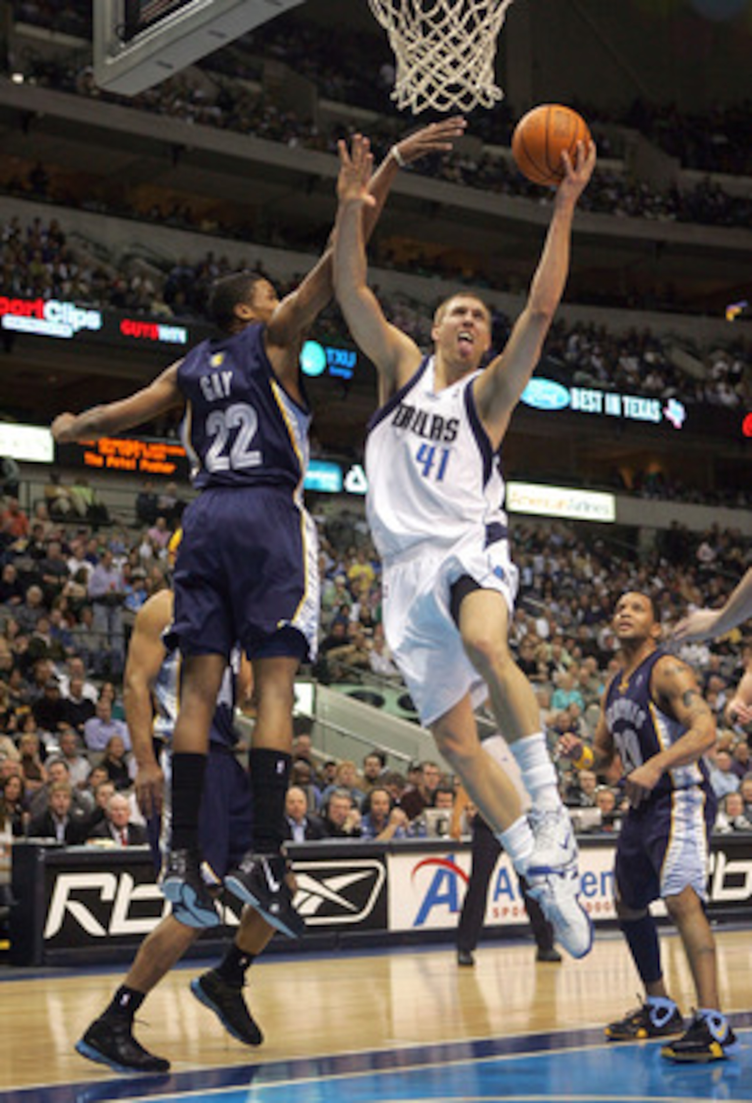 DALLAS - FEBRUARY 07:  Forward Dirk Nowitzki #41 of the Dallas Mavericks drives the hoop against Rudy Gay #22 of the Memphis Grizzlies on February 7, 2007 at the American Airlines Center in Dallas, Texas.  NOTE TO USER: User expressly acknowledges and agr