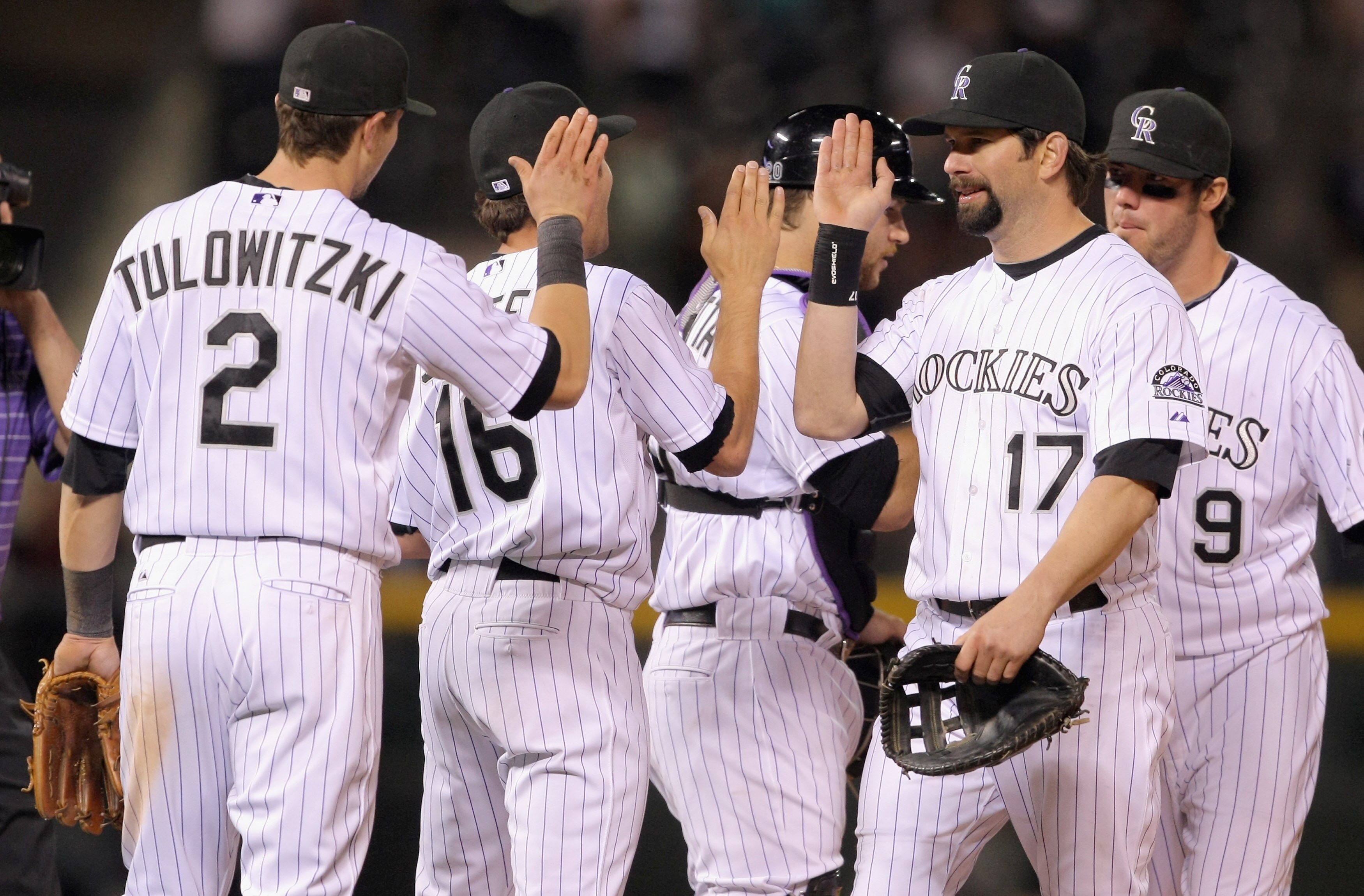 DENVER, CO - MAY 09:  Troy Tulowitzki #2, Huston Street #16, Chris Iannetta #20, Todd Helton #17 and Ian Stewart #9 of the Colorado Rockies celebrate after defeating the New York Mets 2-1 at Coors Field on May 9, 2011 in Denver, Colorado.  (Photo by Doug