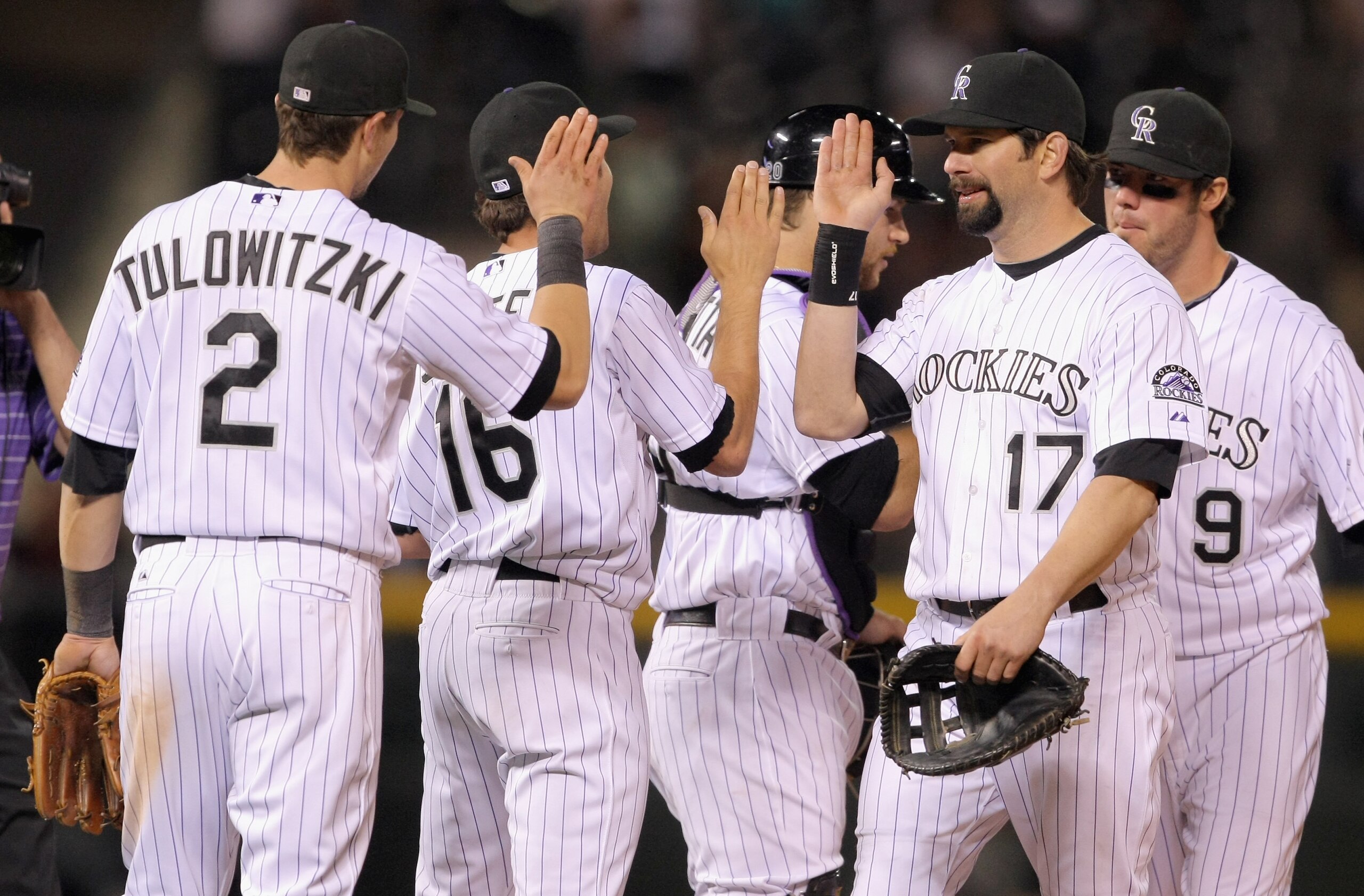 DENVER, CO - MAY 09:  Troy Tulowitzki #2, Huston Street #16, Chris Iannetta #20, Todd Helton #17 and Ian Stewart #9 of the Colorado Rockies celebrate after defeating the New York Mets 2-1 at Coors Field on May 9, 2011 in Denver, Colorado.  (Photo by Doug