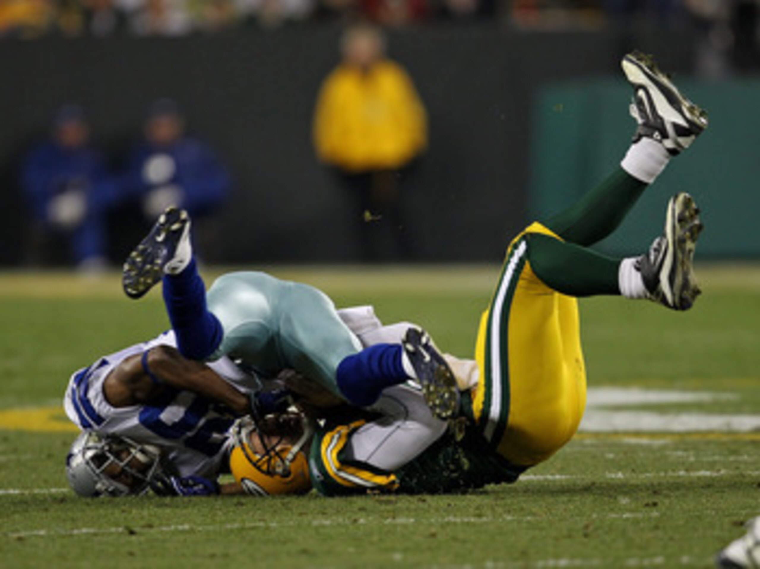 GREEN BAY, WI - NOVEMBER 07: Alan Ball #20 of the Dallas Cowboys sacks Aaron Rodgers #12 of the Green Bay Packers at Lambeau Field on November 7, 2010 in Green Bay, Wisconsin. The Packers defeated the Cowboys 45-7. (Photo by Jonathan Daniel/Getty Images)