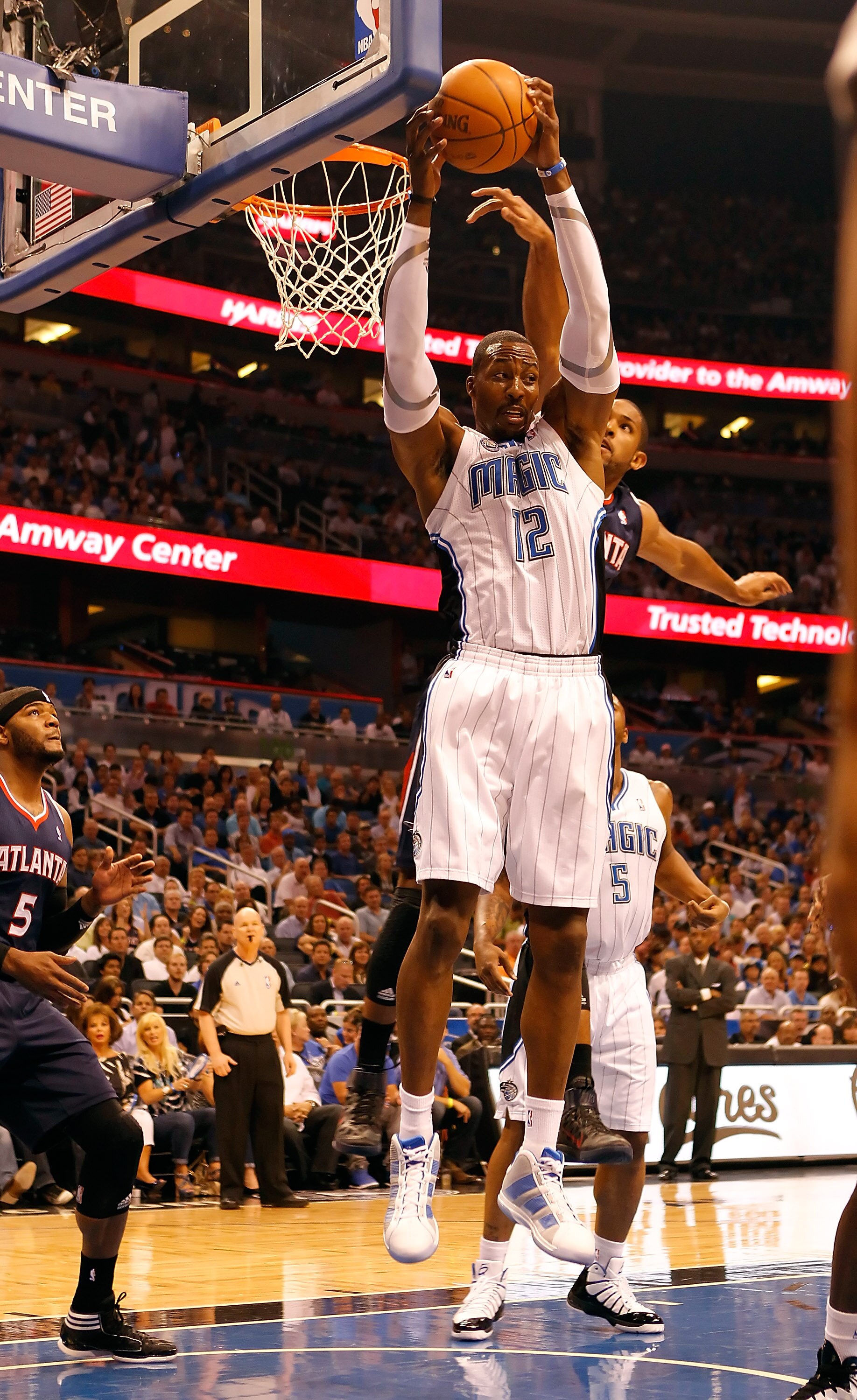 ORLANDO, FL - APRIL 26:  Dwight Howard #12 of the Orlando Magic rebounds against the Atlanta Hawks during Game Five of the Eastern Conference Quarterfinals of the 2011 NBA Playoffs on April 26, 2011 at the Amway Arena in Orlando, Florida.  NOTE TO USER: U