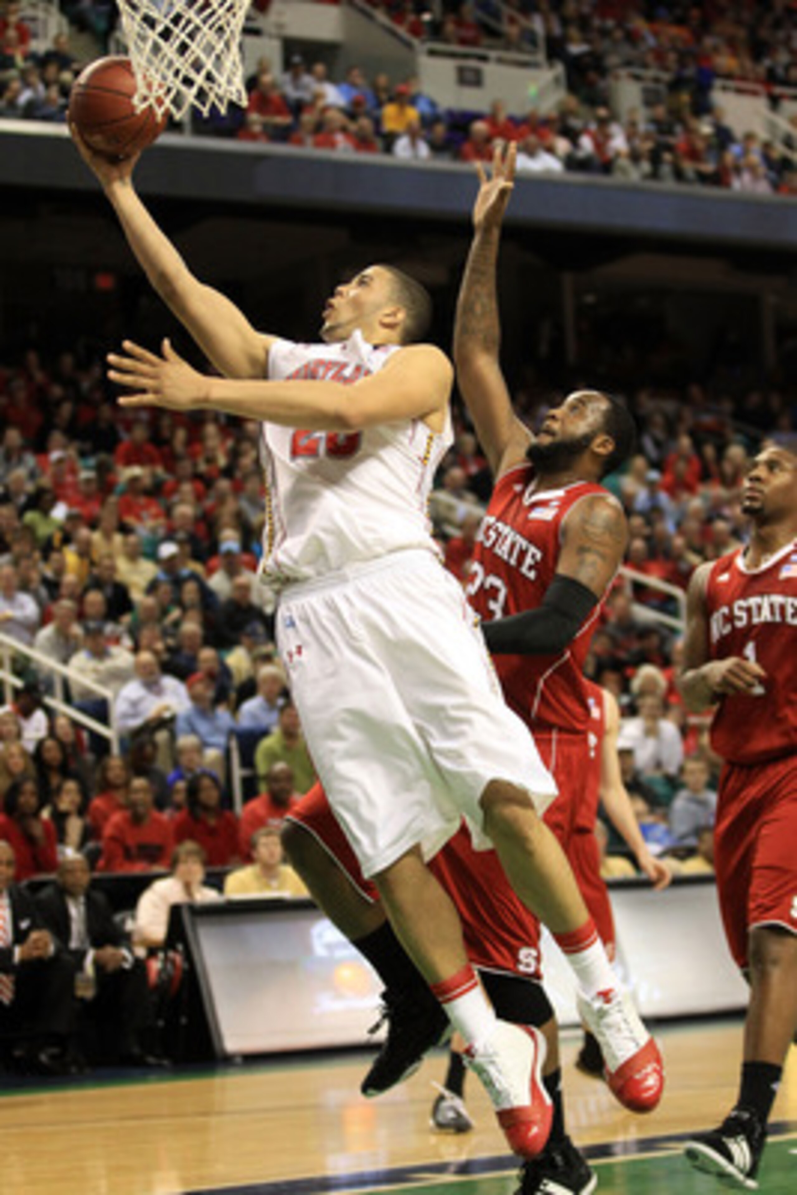 GREENSBORO, NC - MARCH 10:  Jordan Williams #20 of the Maryland Terrapins shoots against Tracy Smith #23 of the North Carolina State Wolfpack during the first half of the game in the first round of the 2011 ACC men's basketball tournament at the Greensbor