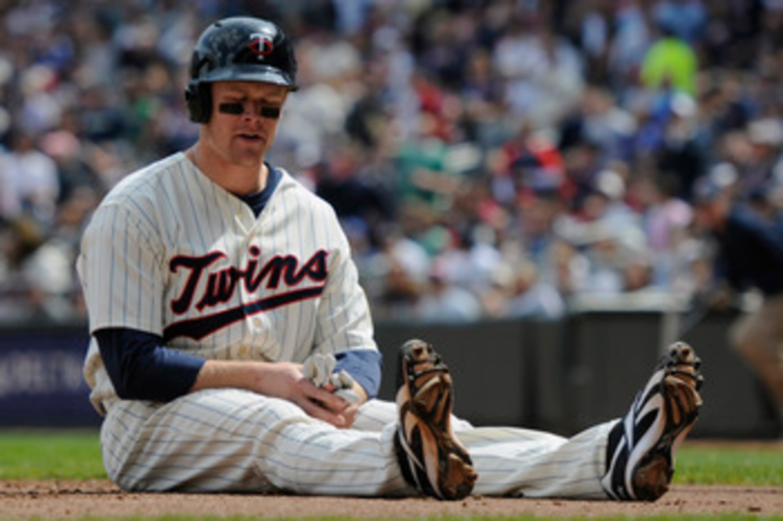 MINNEAPOLIS, MN - APRIL 24: Justin Morneau #33 of the Minnesota Twins reacts after being tagged out at home plate for the final out of the third inning against the Cleveland Indians during their game on April 24, 2011 at Target Field in Minneapolis, Minne