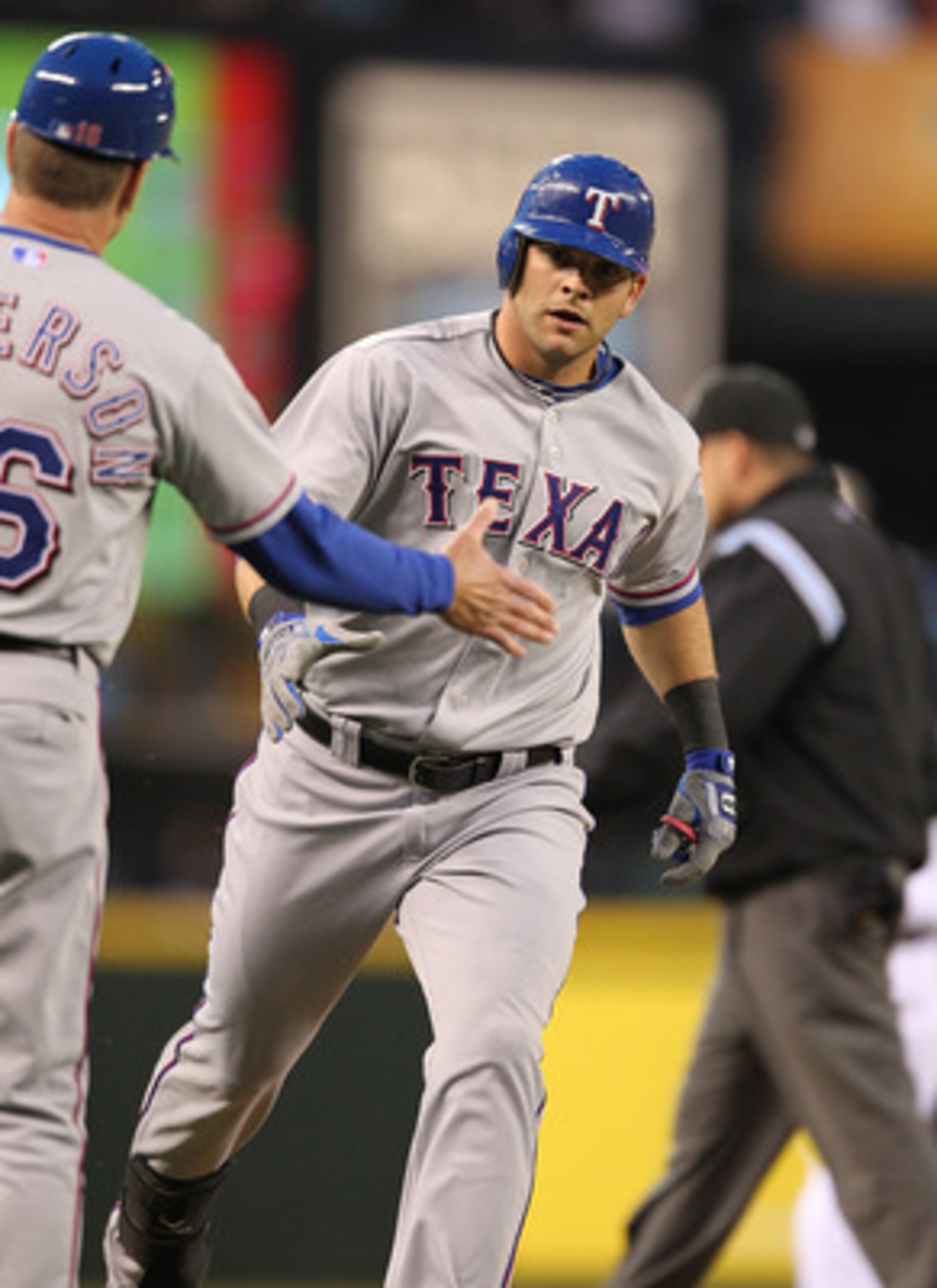 SEATTLE - MAY 04:  Mitch Moreland #18 of the Texas Rangers is congratulated by third base coach Dave Anderson #16 after hitting a solo home run off of starting pitcher Michael Pineda #36 of the Seattle Mariners at Safeco Field on May 4, 2011 in Seattle, W