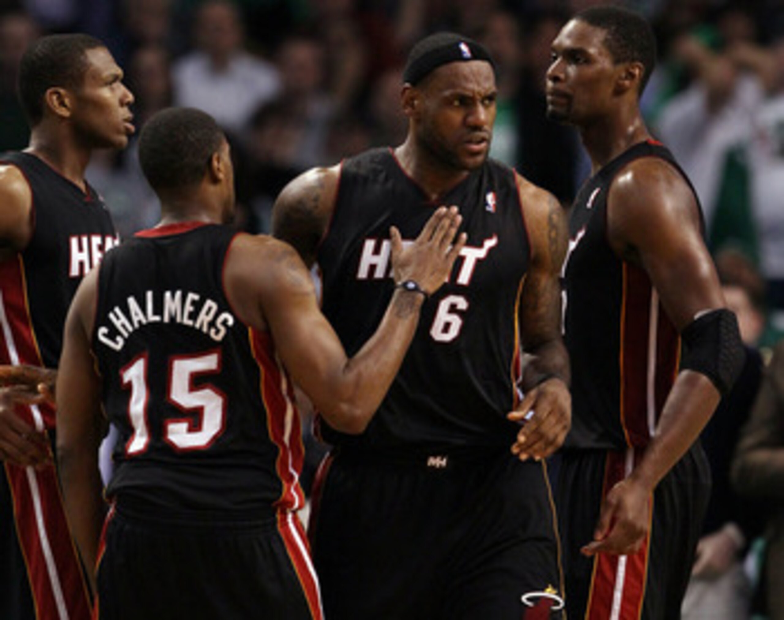 BOSTON, MA - MAY 09: LeBron James #6 of the Miami Heat is congratulated by teammates Chris Bosh  #1 and Mario Chalmers #15 after James drew the foul in the second half against the Boston Celtics in Game Four of the Eastern Conference Semifinals in the 201