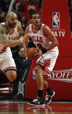 CHICAGO, IL - MAY 04: Joakim Noah #13 of the Chicago Bulls looks to pass after grabbing a rebound as teammate Carlos Boozers #5 heads up the court against the Atlanta Hawks in Game Two of the Eastern Conference Semifinals in the 2011 NBA Playoffs at the U