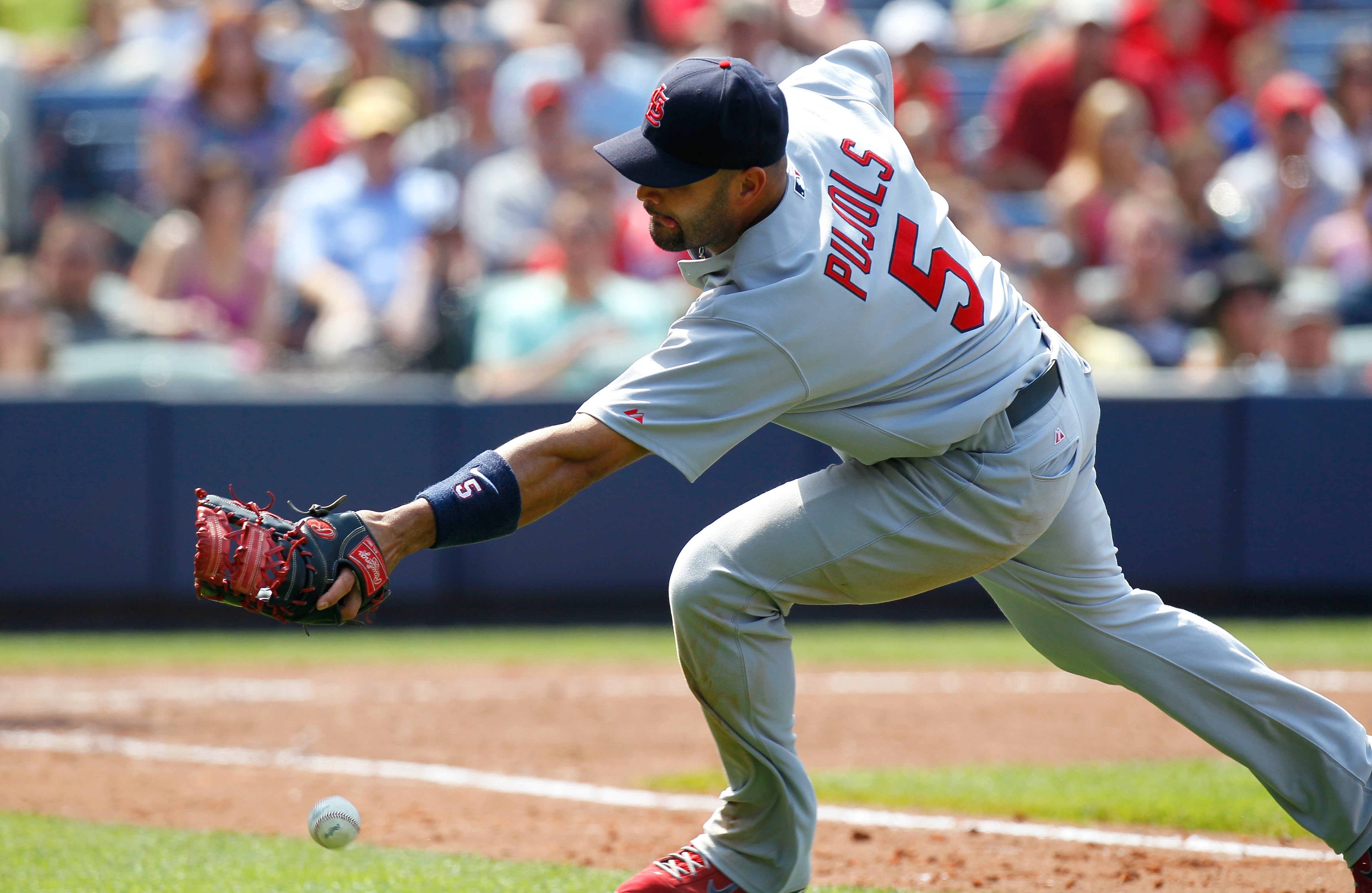 ATLANTA, GA - MAY 01:  Albert Pujols #5 of the St. Louis Cardinals chases after a bunted foul ball hit by Alex Gonzalez #2 of the Atlanta Braves in the seventh inning at Turner Field on May 1, 2011 in Atlanta, Georgia.  (Photo by Kevin C. Cox/Getty Images