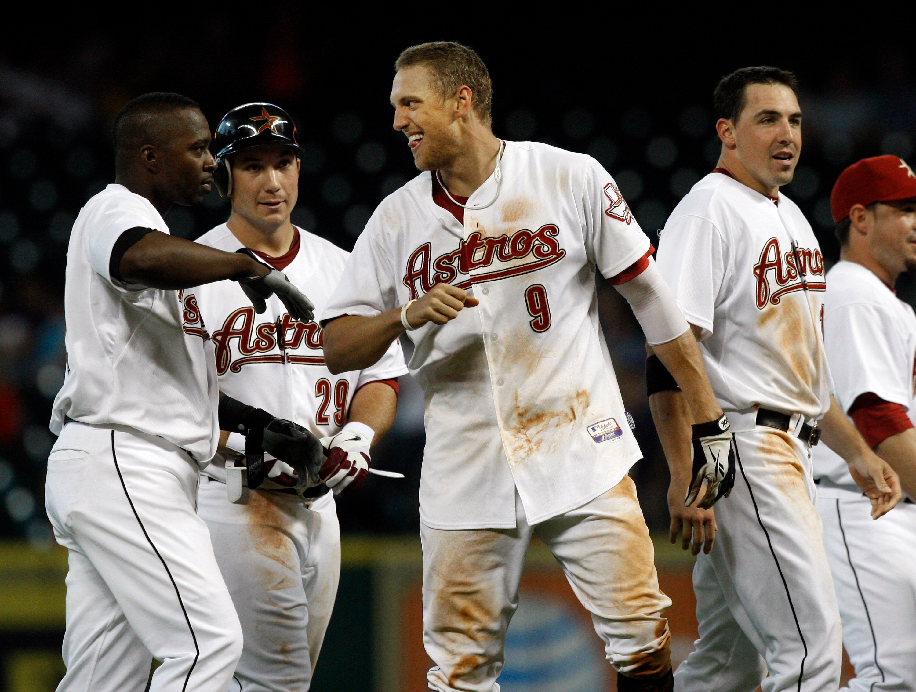 HOUSTON - MAY 11:  Hunter Pence #9 of the Houston Astros celebrates with Bill Hall, left and Brett Wallace #29 after knocking in the winning run in the bottom of  the ninth inning against the Cincinnati Reds at Minute Maid Park on May 11, 2011 in Houston,