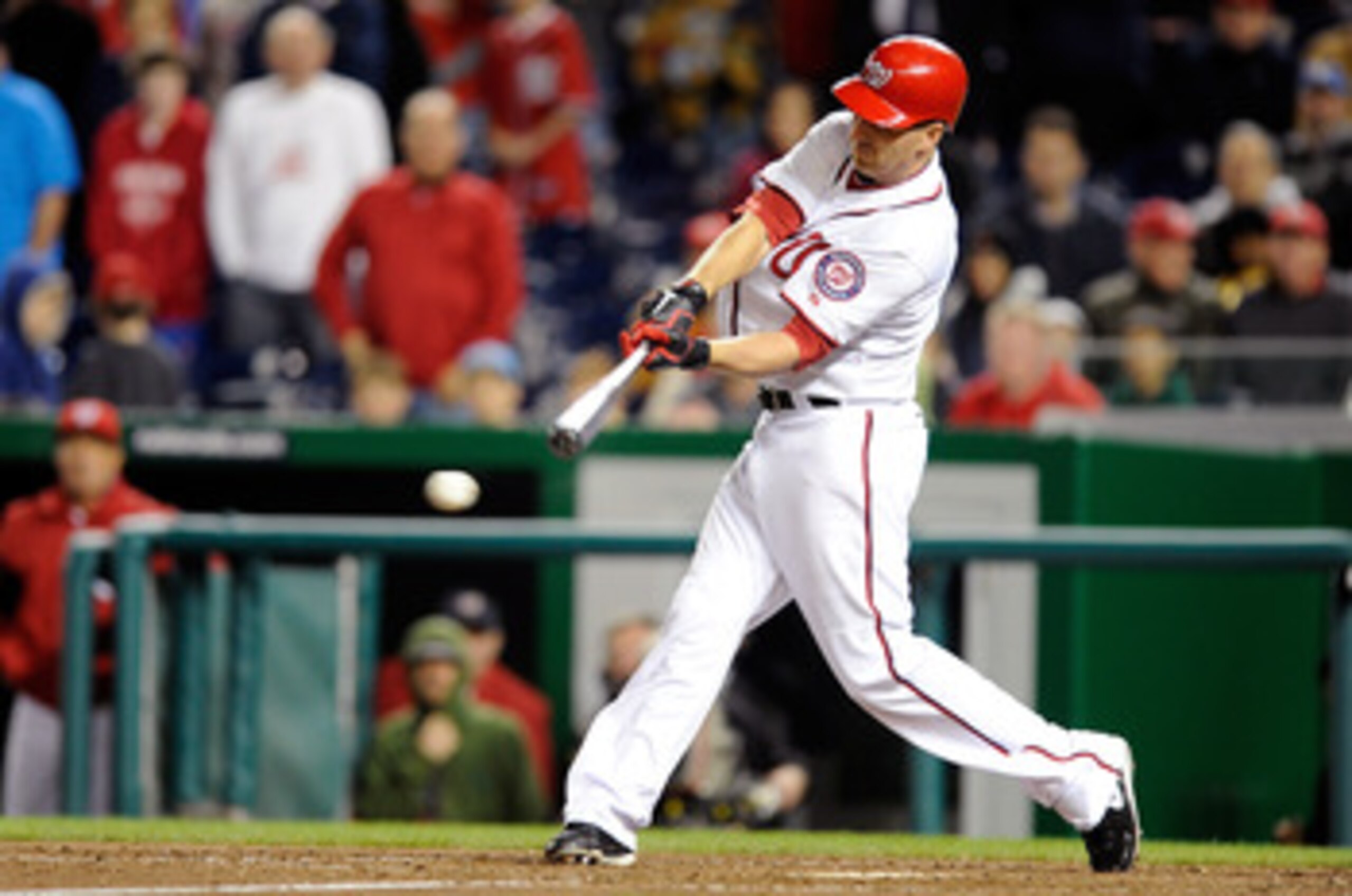 WASHINGTON, DC - APRIL 15:  Adam LaRoche #25 of the Washington Nationals drives in the winning run in the tenth inning against the Milwaukee Brewers at Nationals Park on April 15, 2011 in Washington, DC. The Nationals won the game 4-3. All players, coache